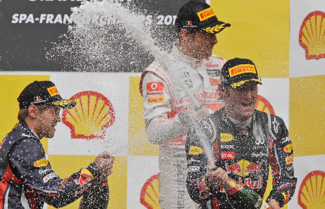 Red Bull driver Sebastian Vettel of Germany, from left, McLaren Mercedes driver Jenson Button of Britain and Red Bull driver Mark Webber of Australia celebrate after  the Belgian  F1 Grand Prix at the Spa-Francorchamps circuit in Spa-Francorchamps, Belgium, Sunday, Aug. 28, 2011.   (AP Photo/Frank Augstein)