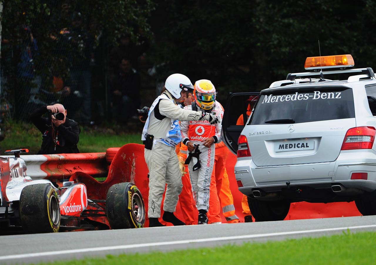SPA FRANCORCHAMPS, BELGIUM - AUGUST 28:  Lewis Hamilton of Great Britain and McLaren is helped into the medical car after crashing out during the Belgian Formula One Grand Prix at the Circuit of Spa Francorchamps on August 28, 2011 in Spa Francorchamps, Belgium.  (Photo by Lars Baron/Getty Images)