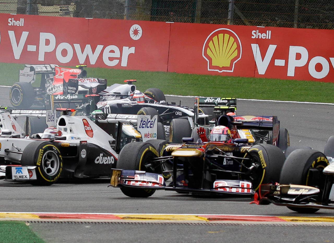 Toro Rosso driver Jaime Alguersuari of Spain gestures as he is hit by another car at the start of the Belgian Formula One Grand Prix in Spa-Francorchamps, Sunday, Aug. 28, 2011. (AP Photo/Frank Augstein)