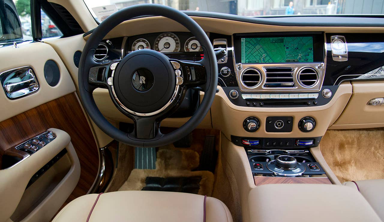 Sticker Price: $284,900 Invoice Price: N/A Fuel Economy: 13 mpg City, 21 mpg Highway  The 2014 Rolls-Royce Wraith has, well, the Rolls-Royce of interiors. From its leather headliner, perforated with 1,340 hand-sewn fiber-optic stars to give the cabin a warm glow, to its one-inch-thick plush, natural lamb's wool floor mats, this car has had luxury hand-stitched into every detail. Drivers are greeted by analog circular instruments on the dash and the open-pore, un-lacquered wood which gives the airy greenhouse an almost nautical feel. Occupants sink into sumptuous seats draped in fine grain leather. There's more lightly dyed cow leather coating the dash and ostrich leather covers the center console.  Research the Rolls-Royce Wraith Rolls-Royce Wraith Overview Rolls-Royce Wraith Photos & Video Local Dealer Price Quote