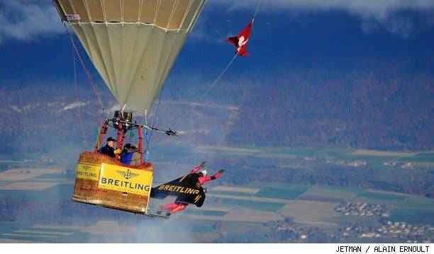 Jetman Yves Rossy flys his jetwing out of a hot air balloon.