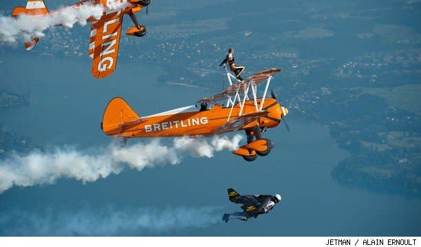 Jetman Yves Rossy flys his jetwing in formation with other aircraft.