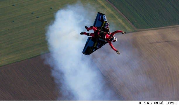 Jetman Yves Rossy flys his jetwing out of a hot air balloon.