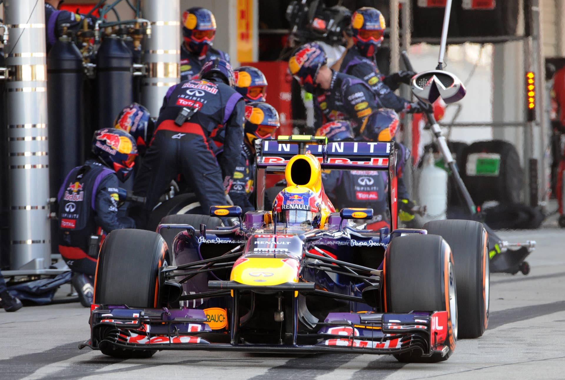 Red Bull driver Mark Webber of Australia leaves his pit during the Formula One Japanese Grand Prix in Suzuka on October 13, 2013.    AFP PHOTO / POOL / TOSHIFUMI KITAMURA        (Photo credit should read TOSHIFUMI KITAMURA/AFP/Getty Images)