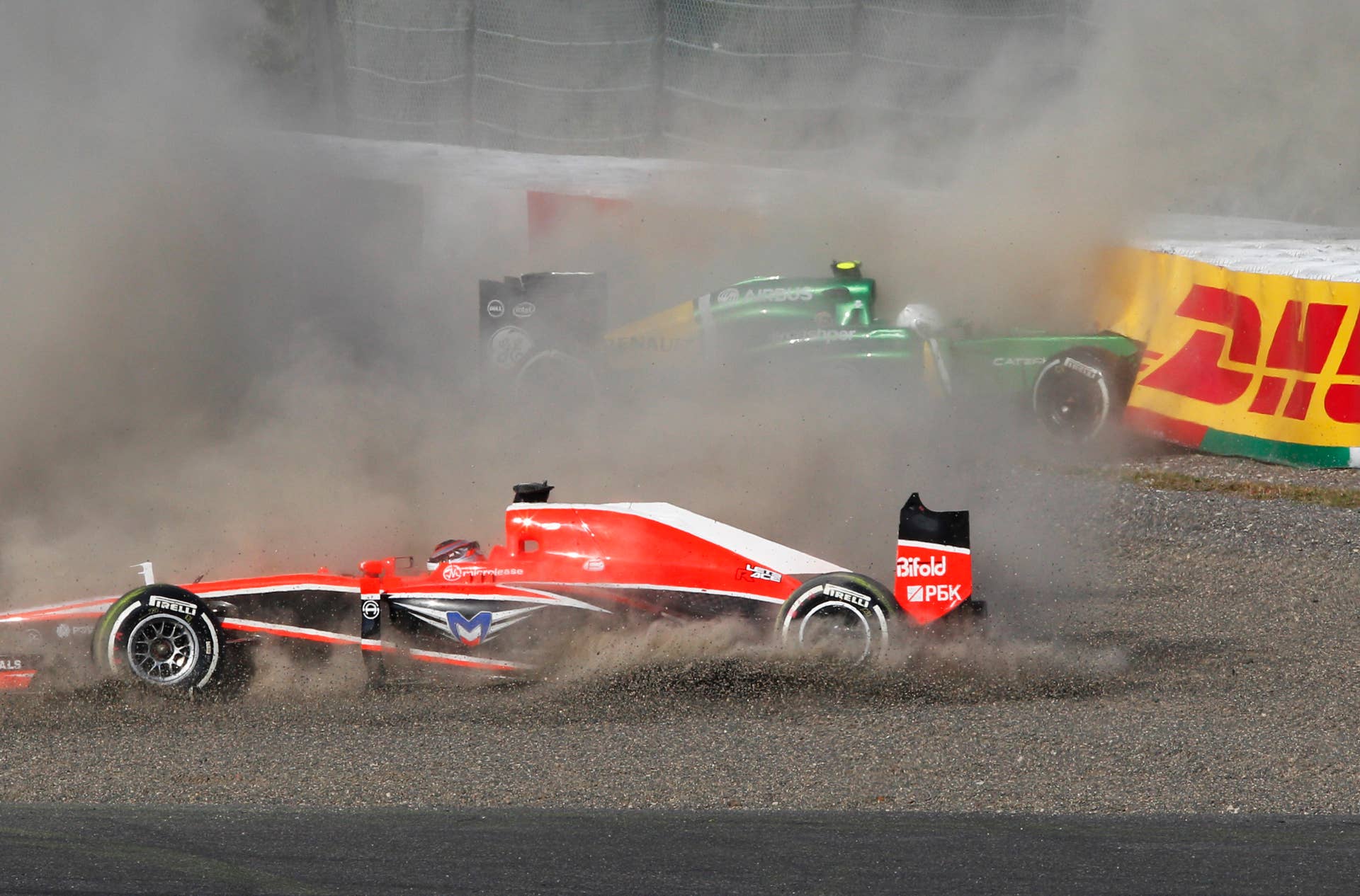 Marussia driver Jules Bianchi, front, and Caterham driver Giedo van der Garde of the Netherlands crash at the start of the Japanese Formula One Grand Prix at the Suzuka circuit in Suzuka, Japan, Sunday, Oct. 13, 2013.(AP Photo/Greg Baker)