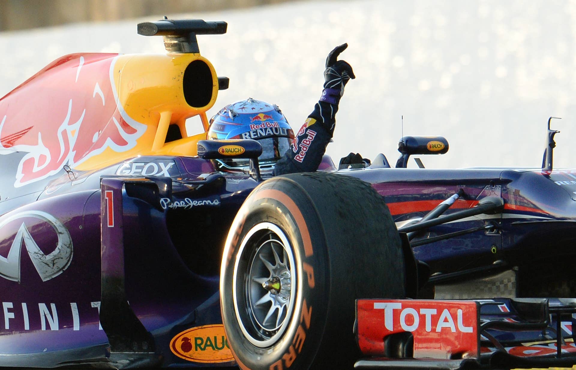 Red Bull driver Sebastian Vettel of Germany gestures to celebrate his victory in the Formula One Japanese Grand Prix in Suzuka on October 13, 2013.      AFP PHOTO/Toru YAMANAKA        (Photo credit should read TORU YAMANAKA/AFP/Getty Images)