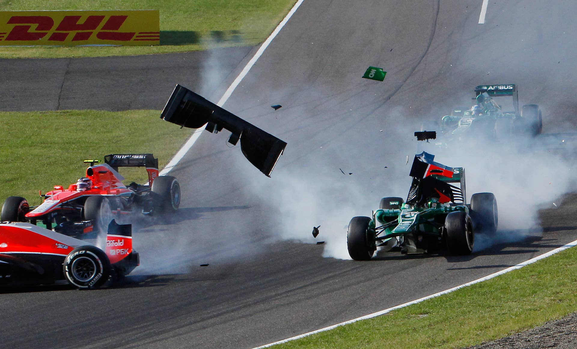 Caterham driver Giedo van der Garde of the Netherlands, right, and Marussia driver Jules Bianchi, left, collide at the start of the Japanese Formula One Grand Prix at the Suzuka circuit in Suzuka, Japan, Sunday, Oct. 13, 2013. (AP Photo/Shuji Kajiyama)
