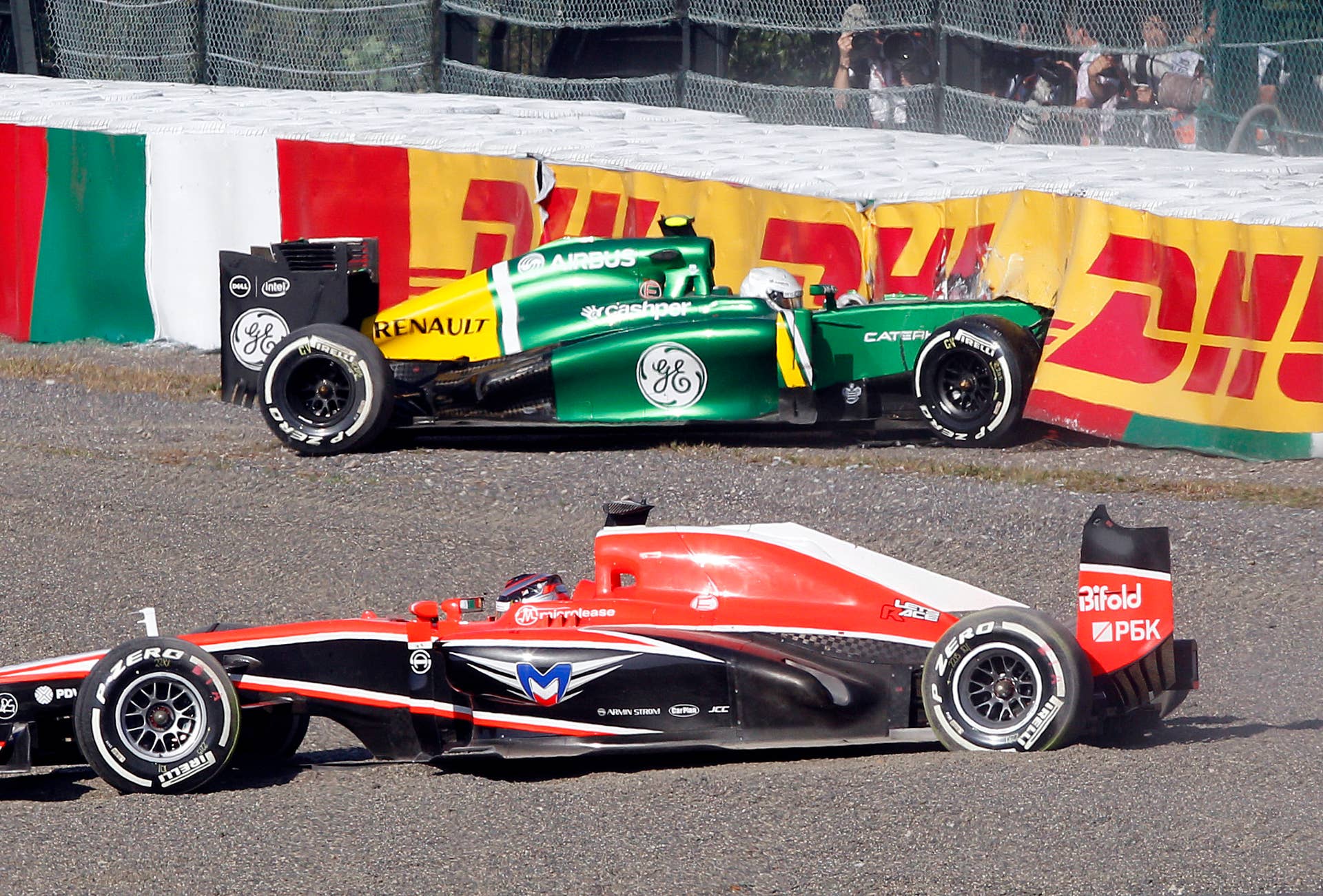 Marussia driver Jules Bianchi, front, and Caterham driver Giedo van der Garde of the Netherlands sit in their cars after crashing at the start of the Japanese Formula One Grand Prix at the Suzuka circuit in Suzuka, Japan, Sunday, Oct. 13, 2013.(AP Photo/Greg Baker)