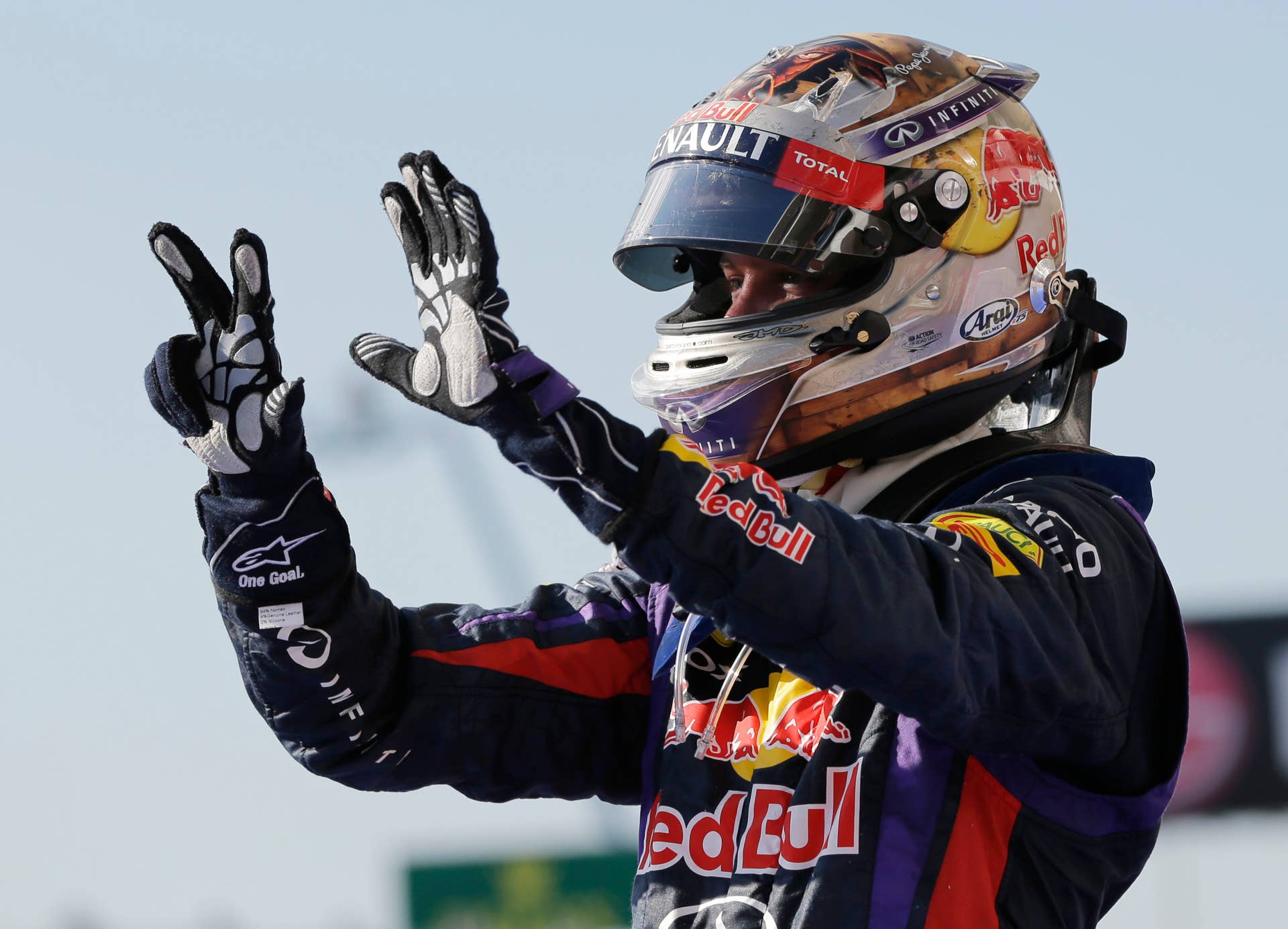 Red Bull driver Sebastian Vettel of Germany holds up eight fingers after winning his eighth race of the season following his win at the Formula One U.S. Grand Prix auto race at the Circuit of the Americas, Sunday, Nov. 17, 2013, in Austin, Texas. (AP Photo/David J. Phillip)