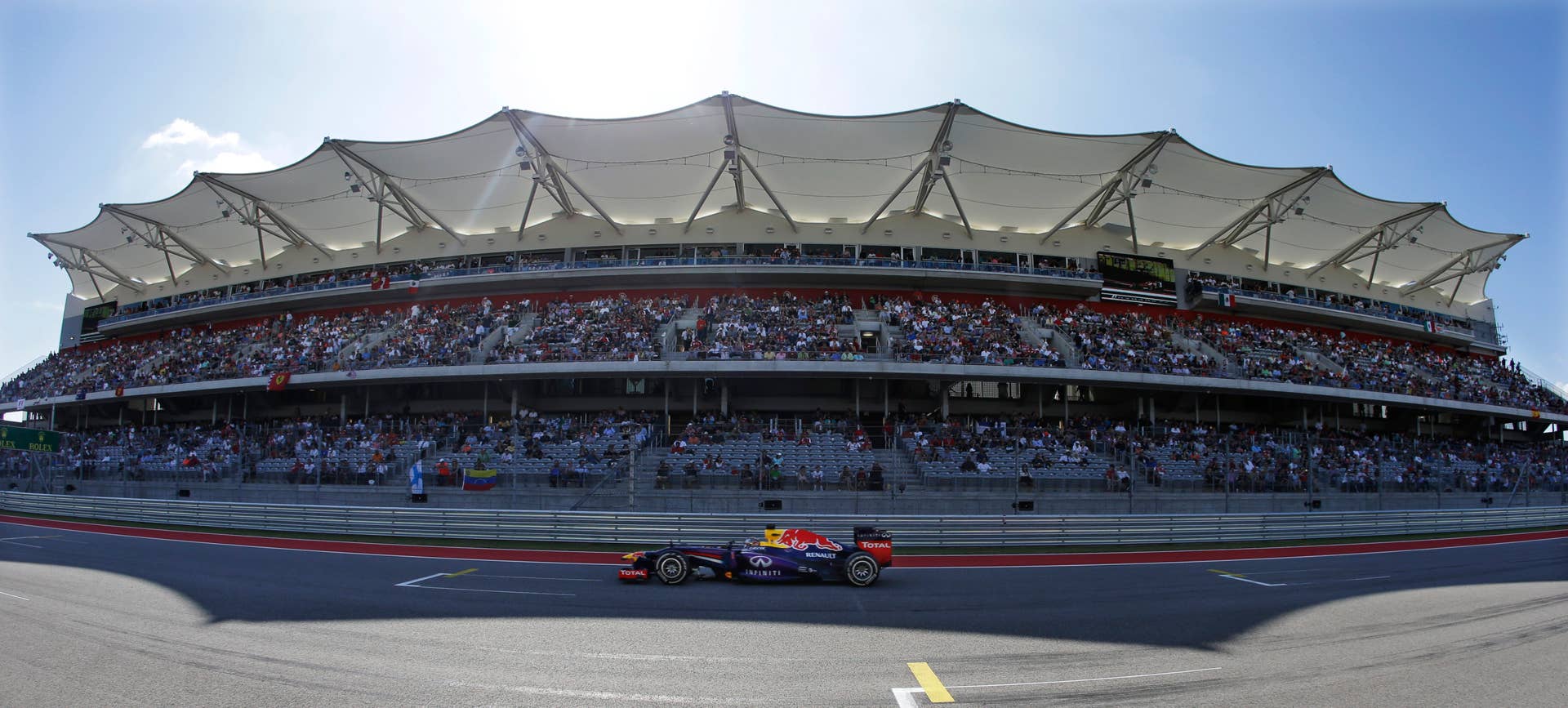 Red Bull driver Sebastian Vettel of Germany races past the grand stand during the Formula One U.S. Grand Prix auto race at the Circuit of the Americas, Sunday, Nov. 17, 2013, in Austin, Texas. (AP Photo/Darron Cummings)