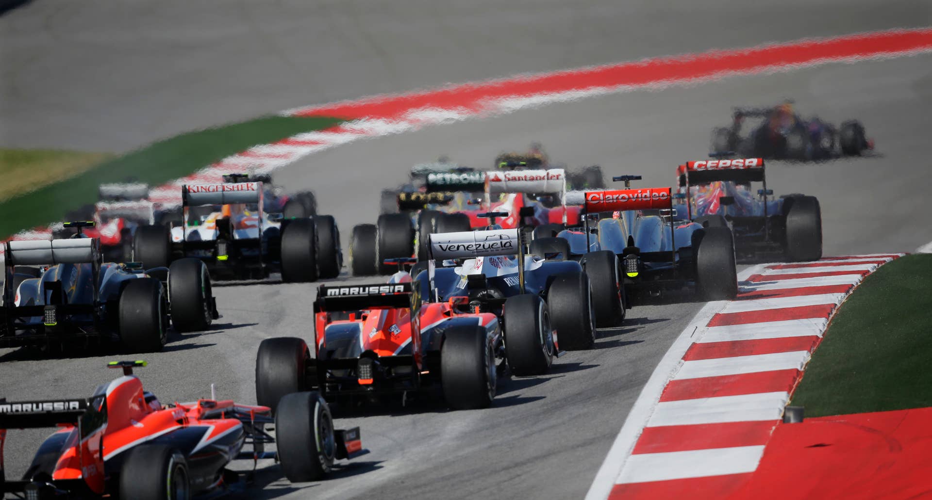 The Formula One field heads towards the second turn at the start of the Formula One U.S. Grand Prix auto race at the Circuit of the Americas, Sunday, Nov. 17, 2013, in Austin, Texas. (AP Photo/Eric Gay)