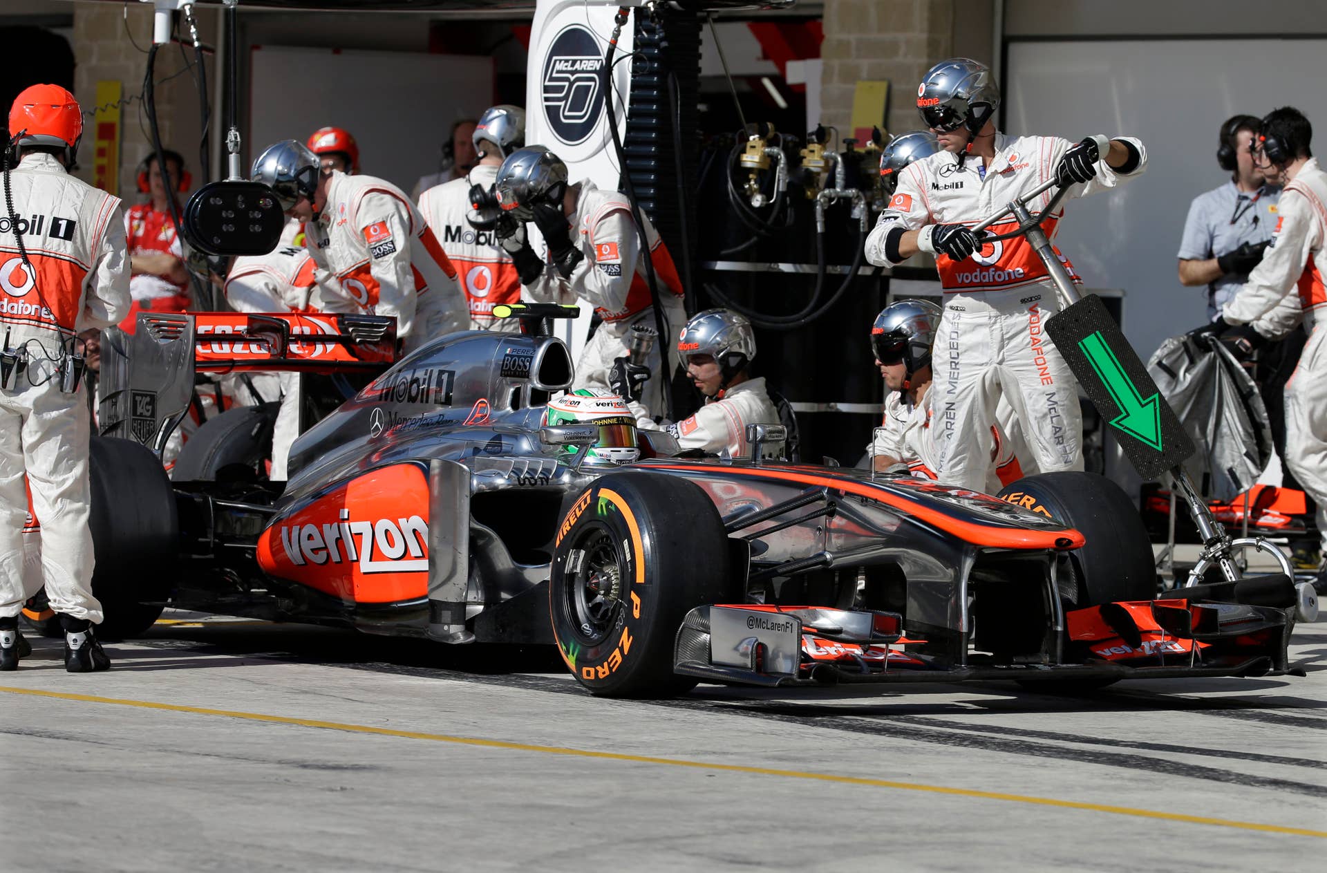 McLaren Mercedes driver Sergio Perez of Mexico leaves the pits after a stop during the Formula One U.S. Grand Prix auto race at the Circuit of the Americas, Sunday, Nov. 17, 2013, in Austin, Texas. (AP Photo/Darron Cummings)