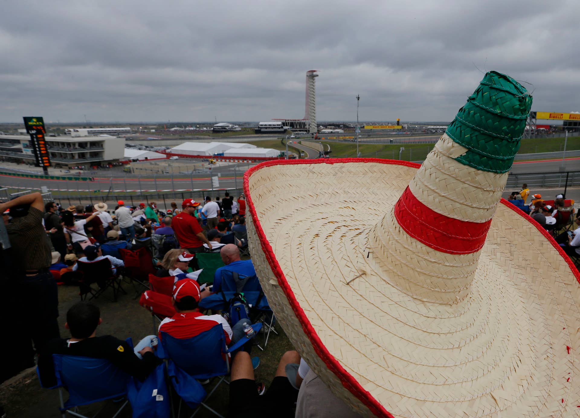 Baltazar Gomez, from Austin, Texas, waits for the Formula One U.S. Grand Prix auto race at the Circuit of the Americas, Sunday, Nov. 17, 2013, in Austin, Texas. (AP Photo/David J. Phillip)