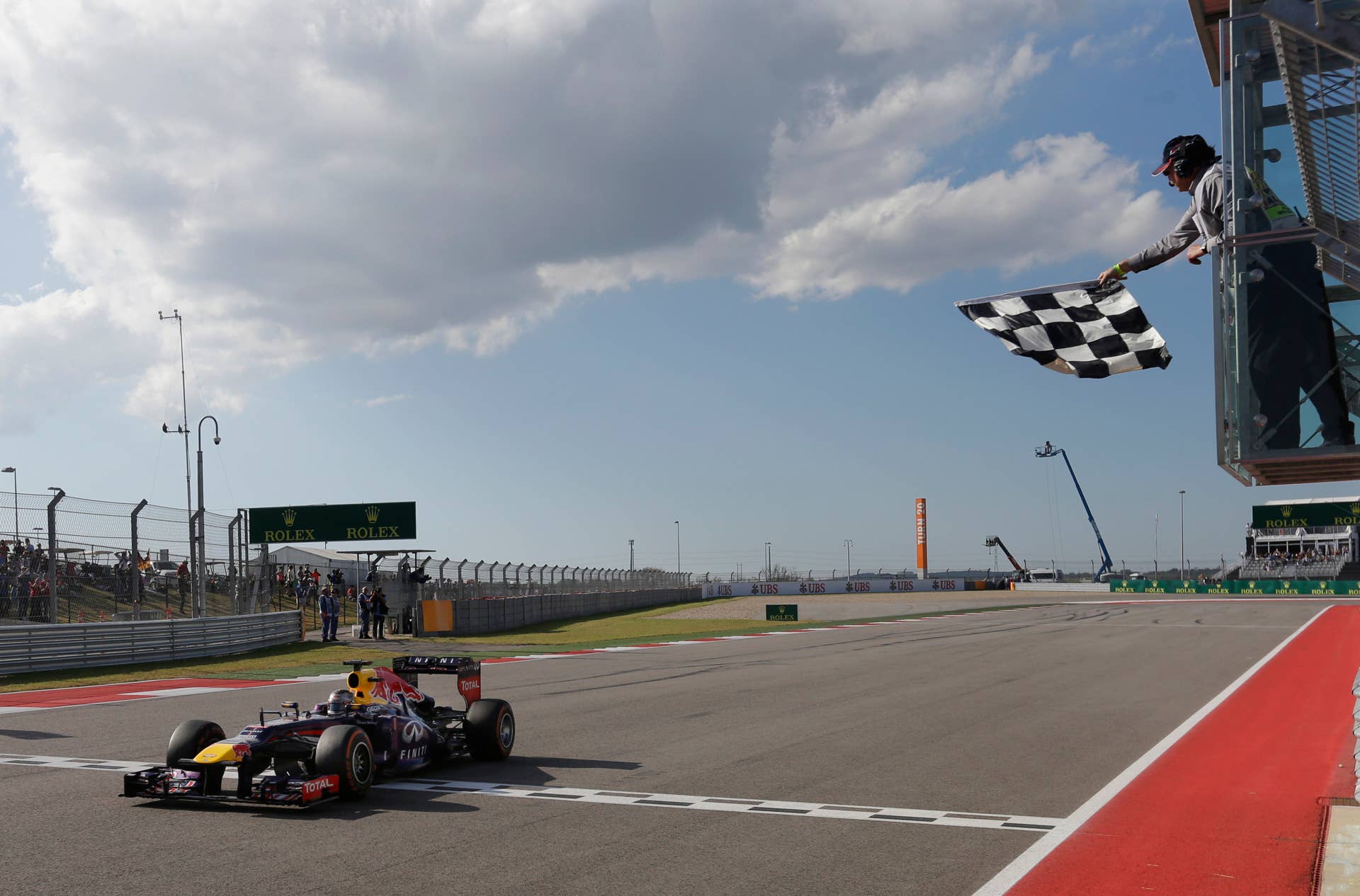 Red Bull driver Sebastian Vettel of Germany crosses the finish line to win the Formula One U.S. Grand Prix auto race at the Circuit of the Americas, Sunday, Nov. 17, 2013, in Austin, Texas. (AP Photo/Darron Cummings)