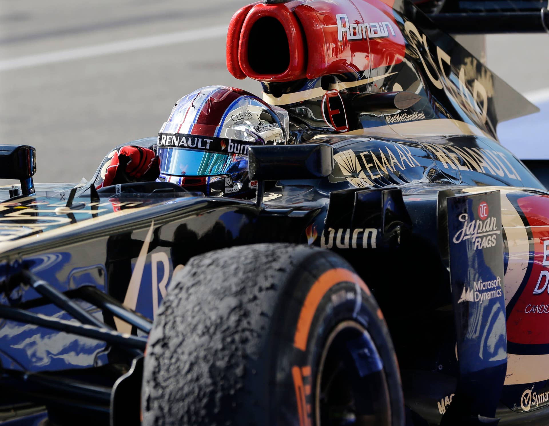 Lotus driver Romain Grosjean of Switzerland pumps his fist following his second place finish in the Formula One U.S. Grand Prix auto race at the Circuit of the Americas, Sunday, Nov. 17, 2013, in Austin, Texas. (AP Photo/David J. Phillip)