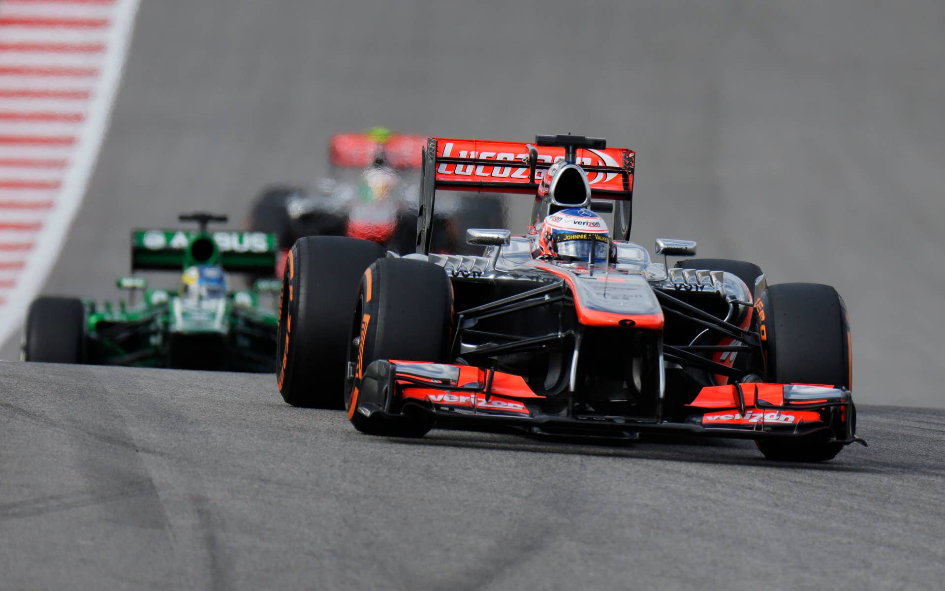McLaren Mercedes driver Jenson Button of Britain races during the qualifying session for the Formula One U.S. Grand Prix auto race at the Circuit of the Americas, Saturday, Nov. 16, 2013, in Austin, Texas. (AP Photo/Eric Gay)