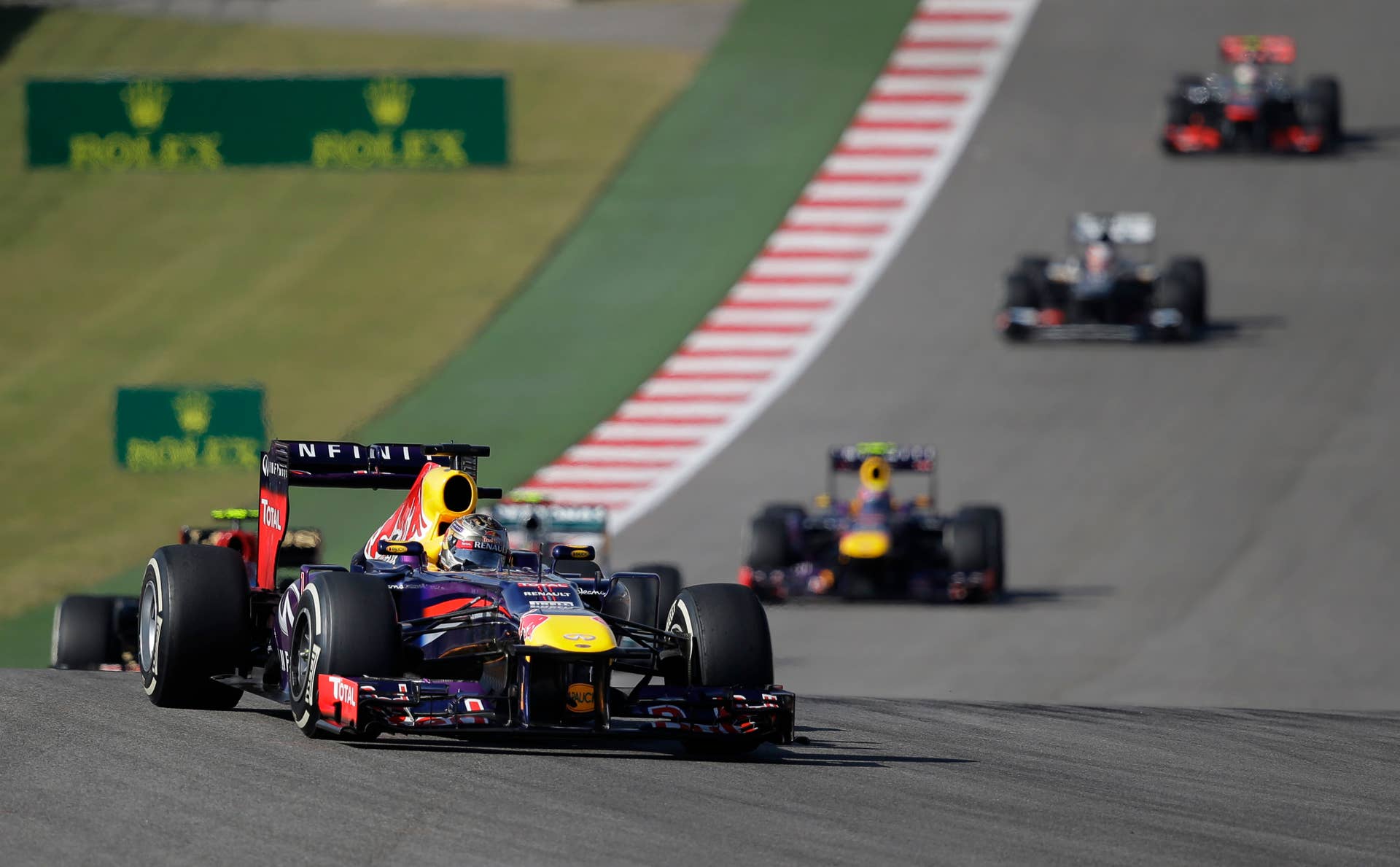 Red Bull driver Sebastian Vettel of Germany leads the field during a yellow flag on the course during the Formula One U.S. Grand Prix auto race at the Circuit of the Americas, Sunday, Nov. 17, 2013, in Austin, Texas. (AP Photo/Eric Gay)