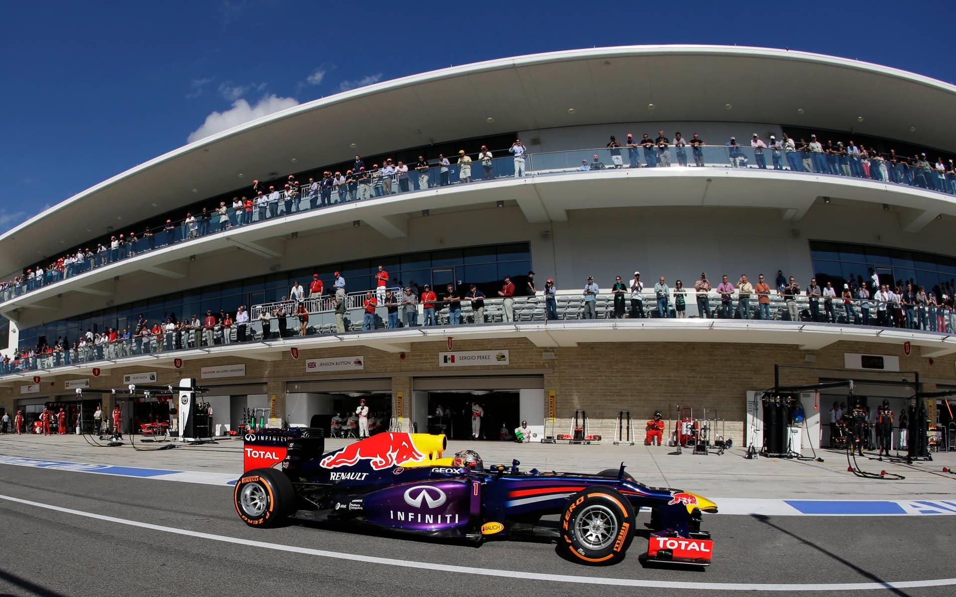 Red Bull driver Sebastian Vettel of Germany drives through the pits after a stop during the Formula One U.S. Grand Prix auto race at the Circuit of the Americas, Sunday, Nov. 17, 2013, in Austin, Texas. (AP Photo/Darron Cummings)