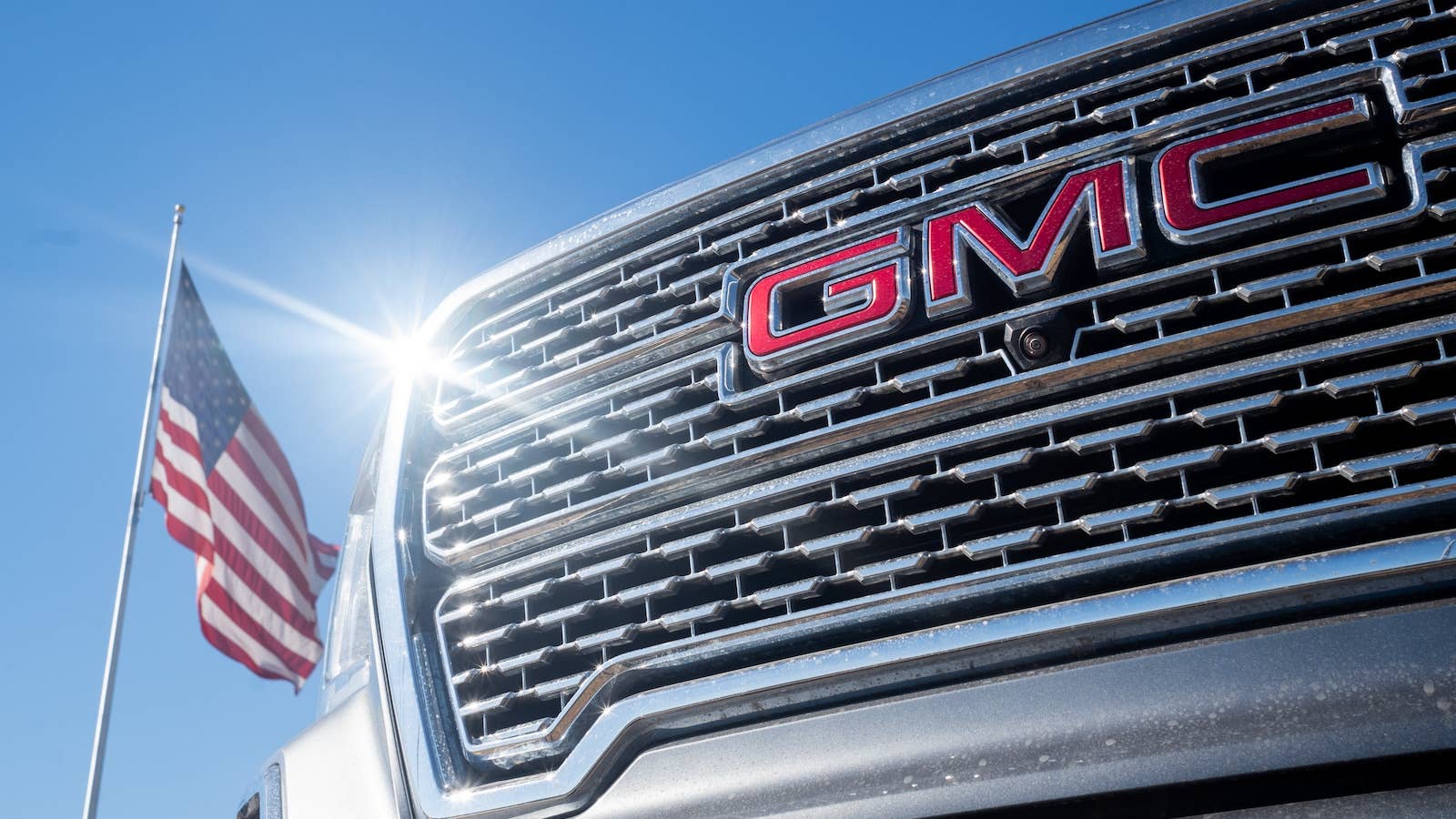 A GMC pickup truck displayed for sale at a General Motors dealership