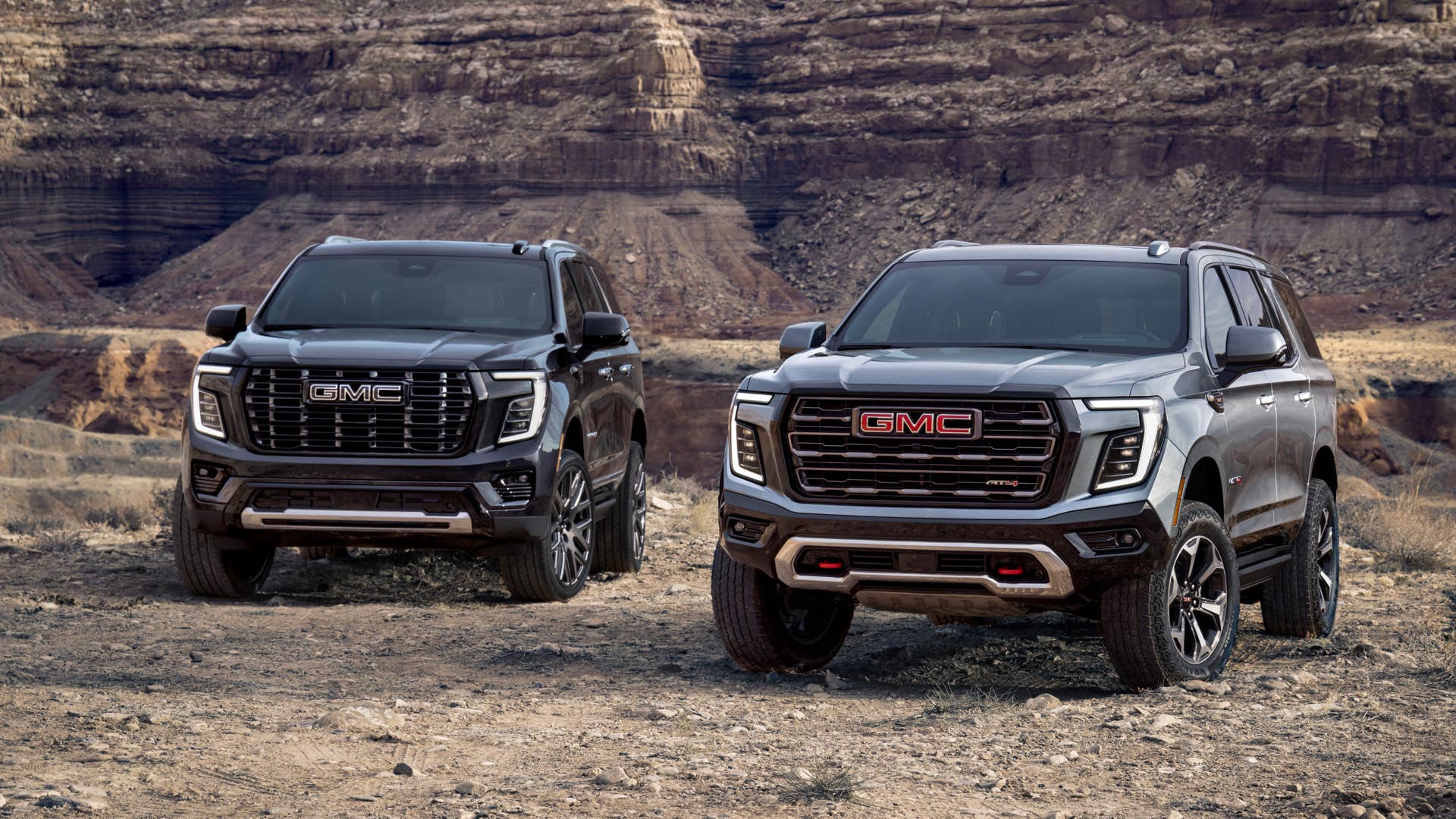 Pack view of the 2025 GMC Yukon, including the AT4 Ultimate (right) and Denali Ultimate (left).