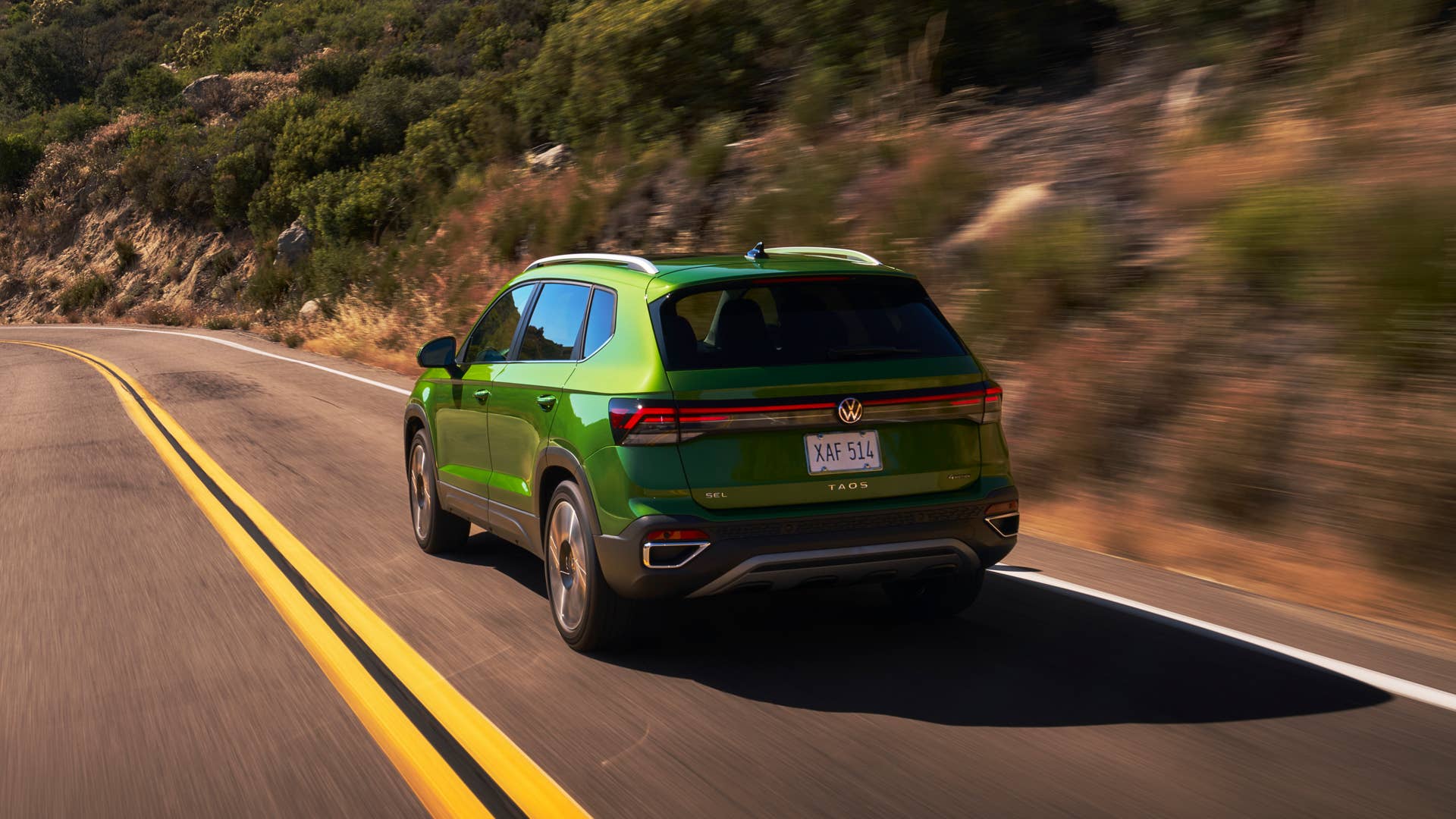 2025-2026 Volkswagen Taos in Bright Moss Green rear view driving