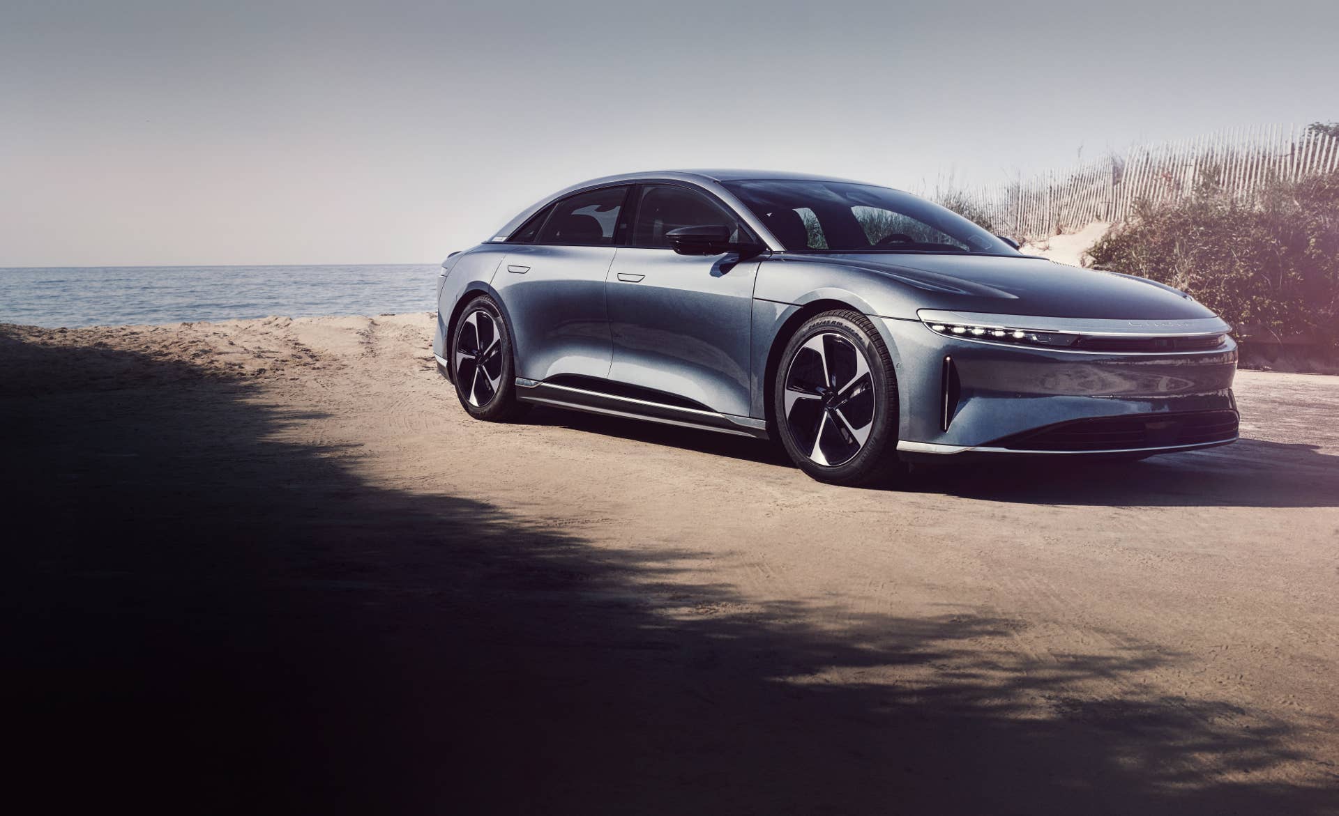 The Lucid Air Pure on a beach