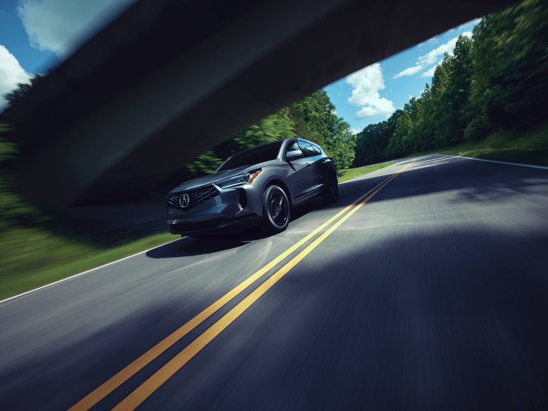 The 2025 Acura RDX driving at speed