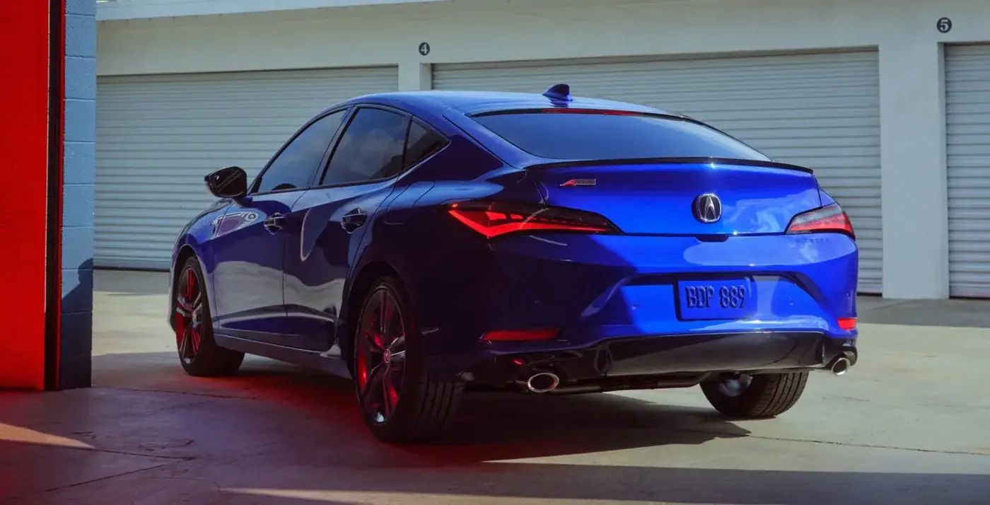 Rear 3/4 view of a blue 2025 Acura Integra