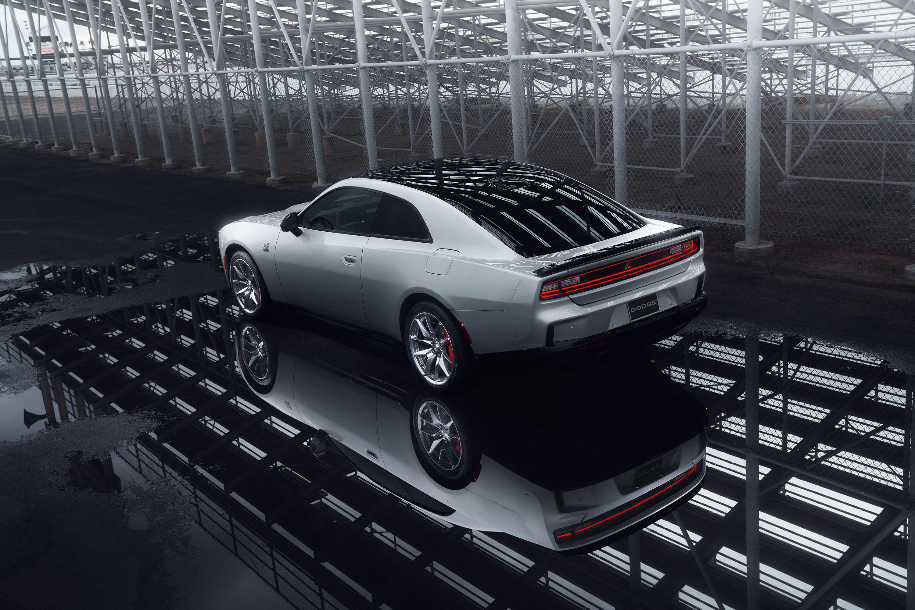 Rear 3/4 view of a silver New Dodge Charger EV with scat pack