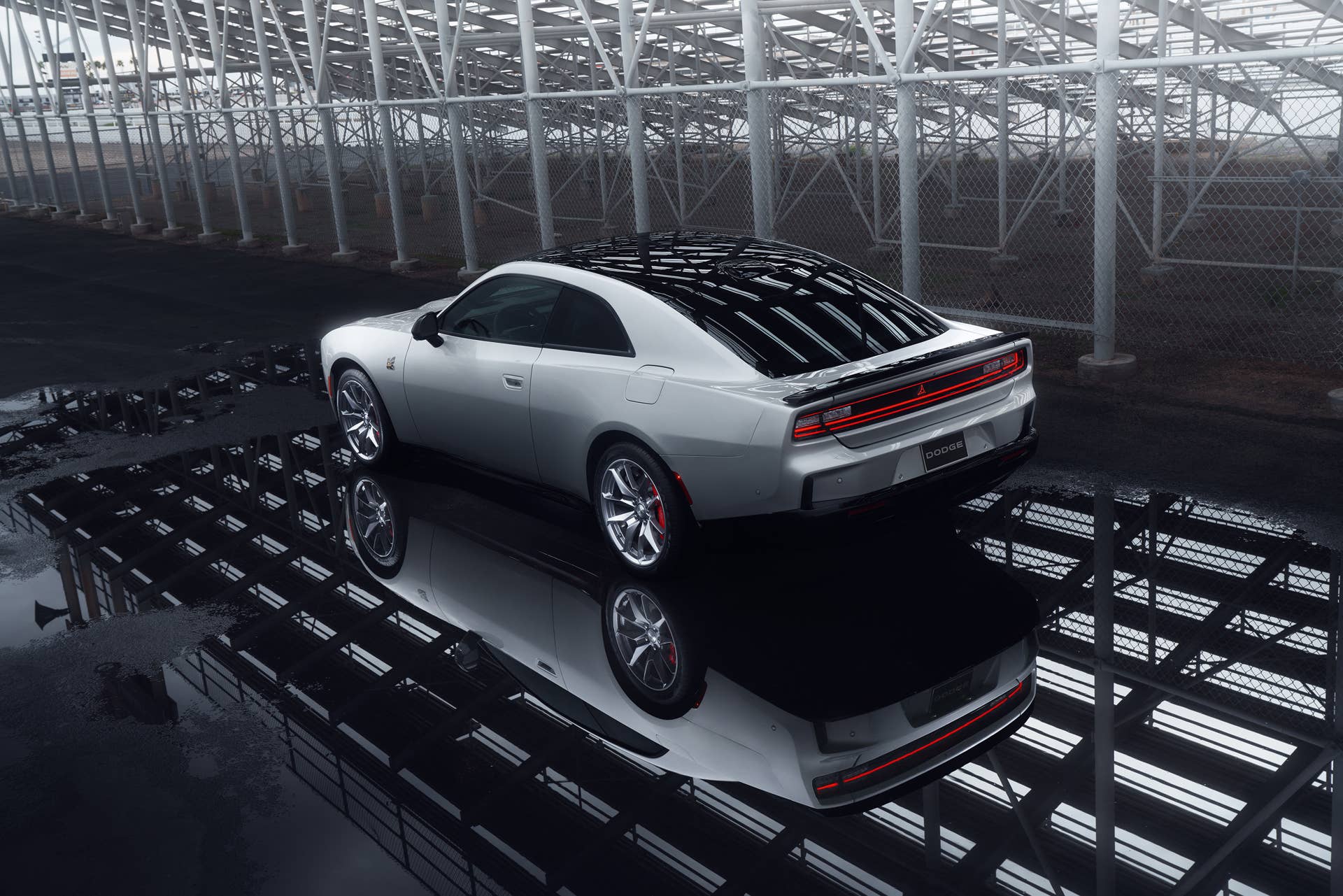 Rear 3/4 view of a silver New Dodge Charger EV with scat pack
