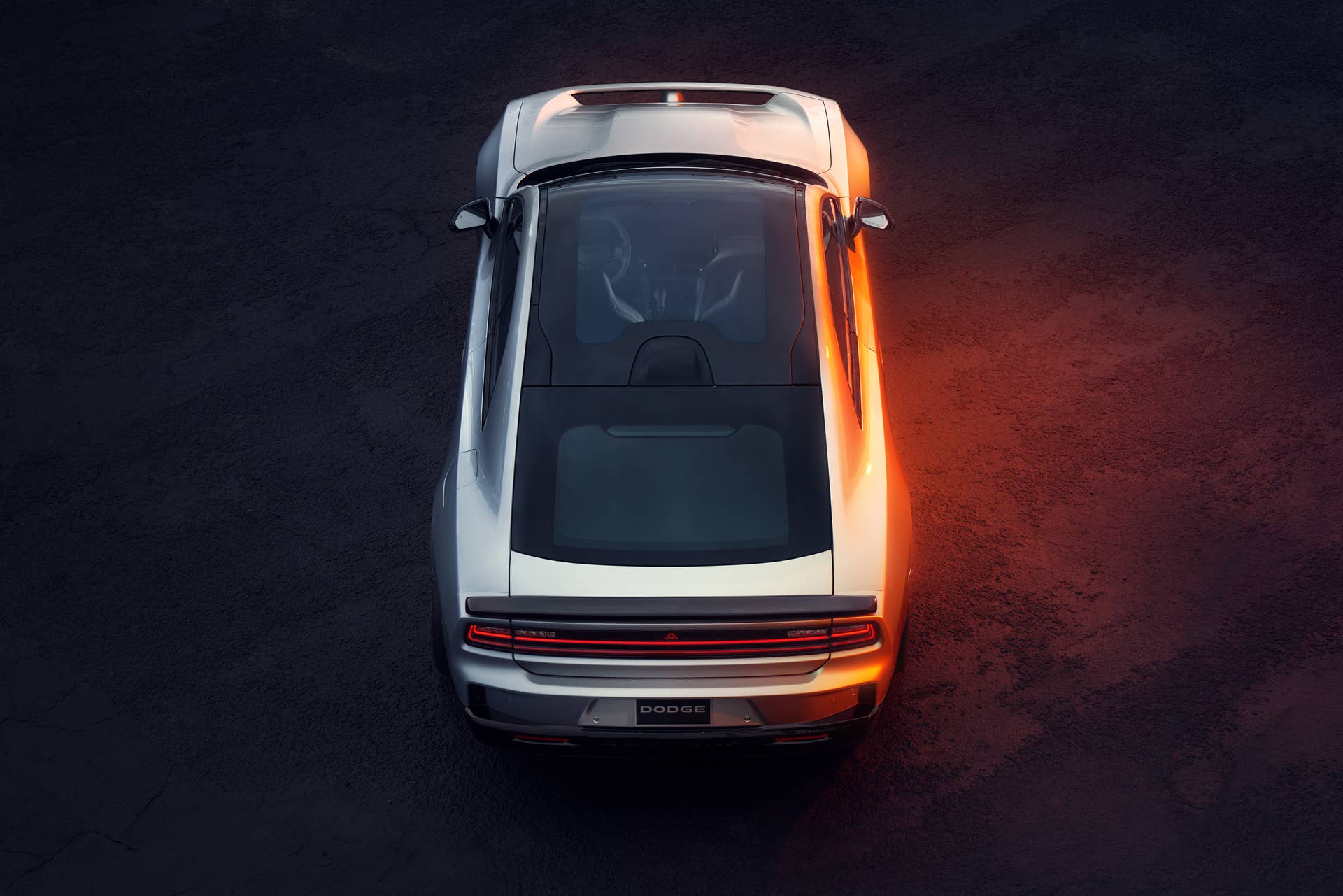 top rear view of a 2025 Dodge Charger EV and its full length glass roof