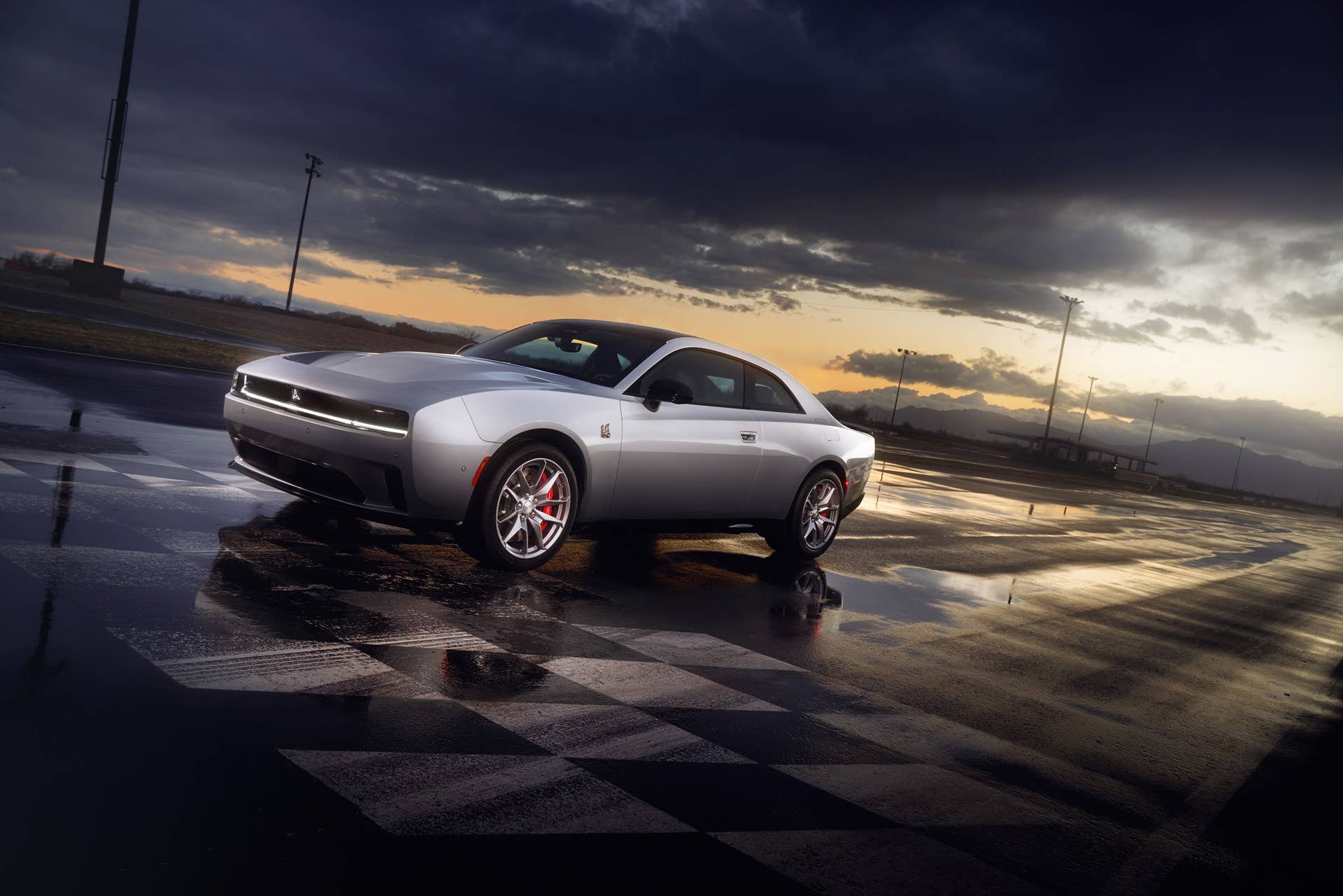 2025 Dodge Charger EV on a wet finish line at dusk