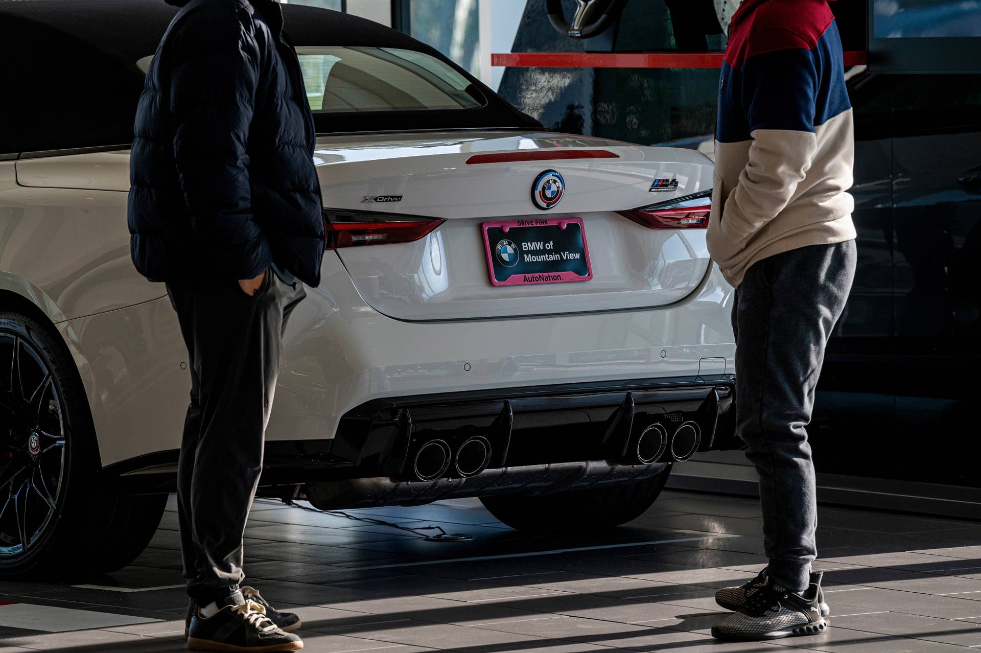 Customers look at a vehicle at a BMW dealership in Mountain View, California, US, on Wednesday, Dec. 14, 2022. Vehicle sales declined in November, due in part to a drop in the prices of used cars and trucks. Photographer: David Paul Morris/Bloomberg via Getty Images