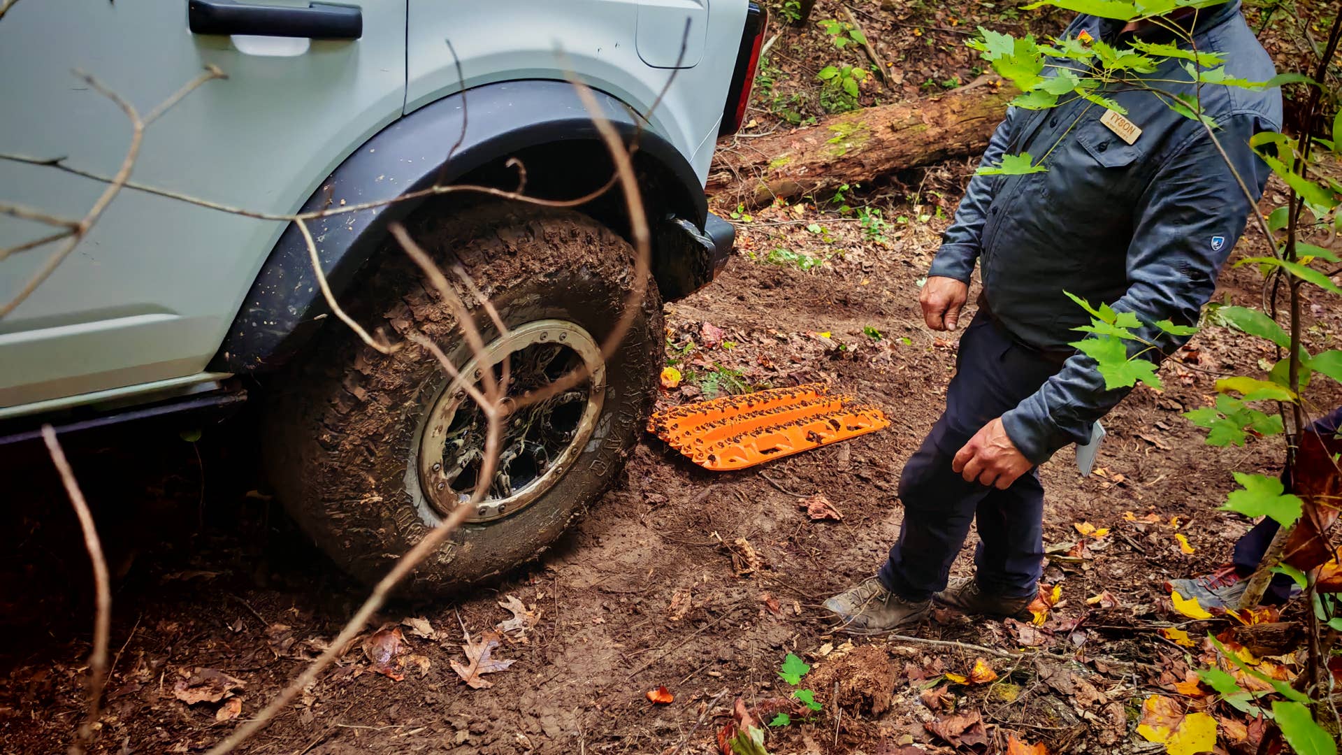 A traction board being used to help a Ford Bronco up a hill