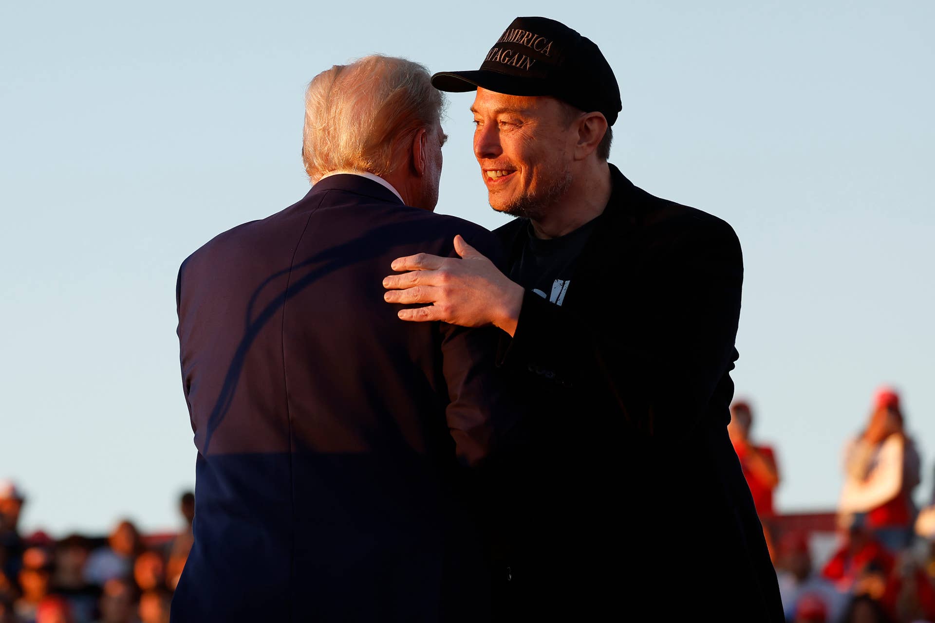 BUTLER, PENNSYLVANIA - OCTOBER 05: Elon Musk embraces Republican presidential nominee, former President Donald Trump during a campaign rally at the Butler Farm Show fairgrounds on October 05, 2024 in Butler, Pennsylvania. This is the first time that Trump has returned to Butler since he was injured during an attempted assassination on July 13.  (Photo by Anna Moneymaker/Getty Images)