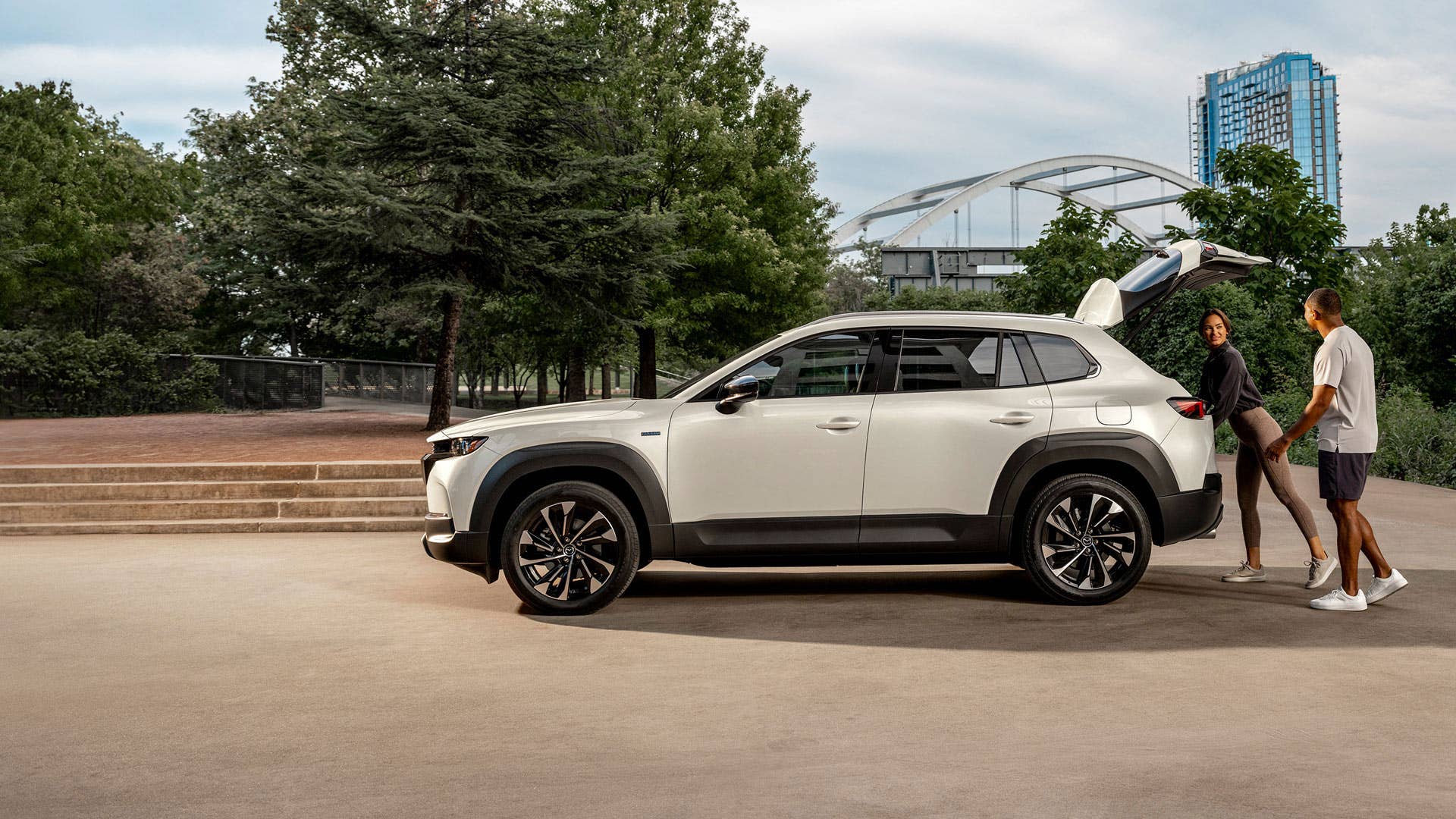 A couple loading the trunk of the Mazda CX-50 Hybrid