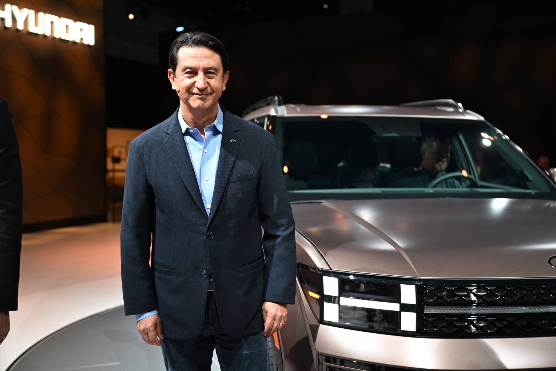 Hyundai Global President and Chief Operating Officer Jose Munoz poses beside the newly unveiled 2024 Santa Fe at the Hyundai press conference at Automobility LA.