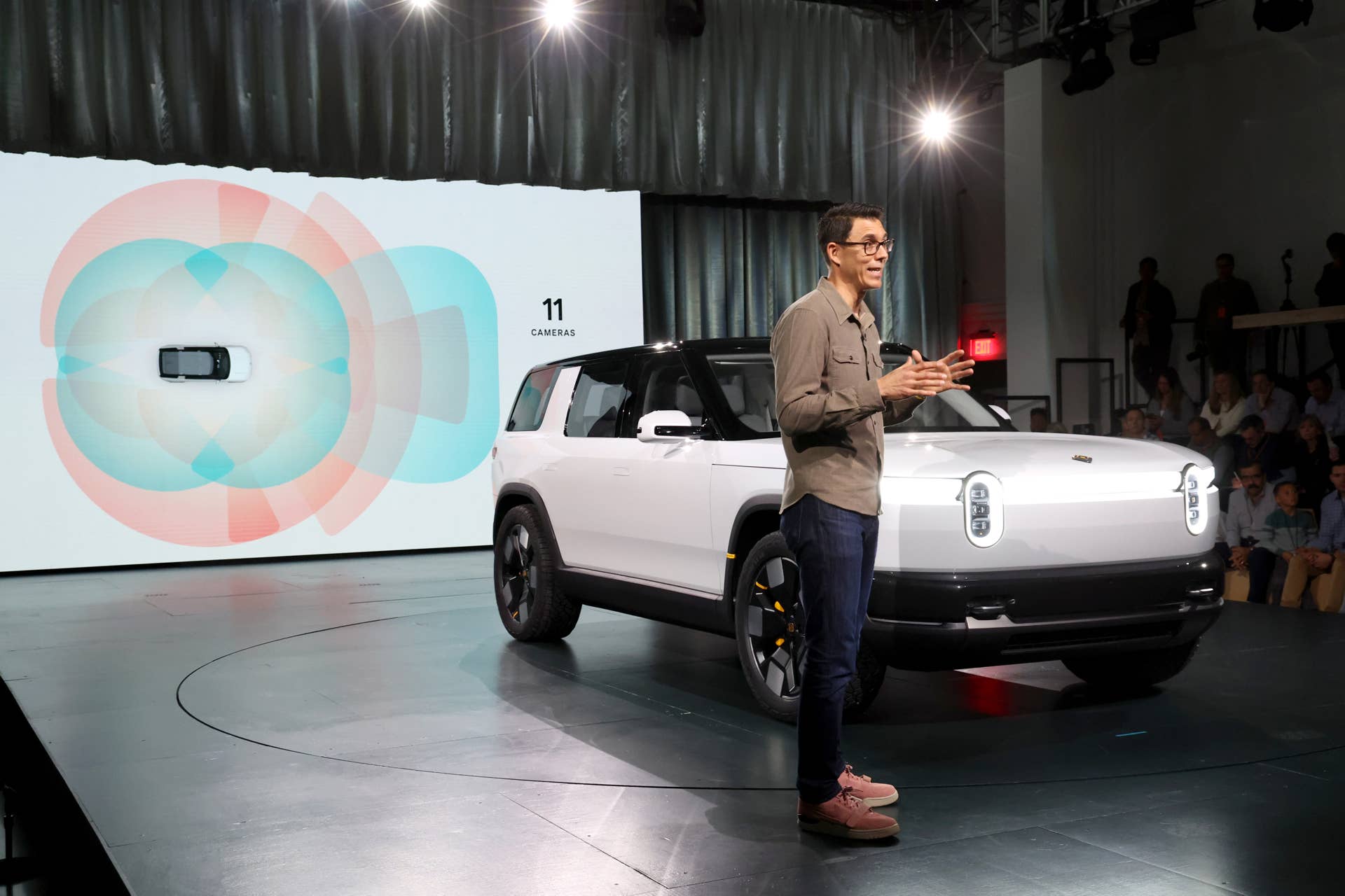 LAGUNA BEACH, CALIFORNIA - MARCH 07: Founder and CEO of Rivian RJ Scaringe speaks onstage during the Rivian Reveals All-Electric R2 Midsize SUV event at Rivian South Coast Theater on March 07, 2024 in Laguna Beach, California. (Photo by Phillip Faraone/Getty Images for Rivian)