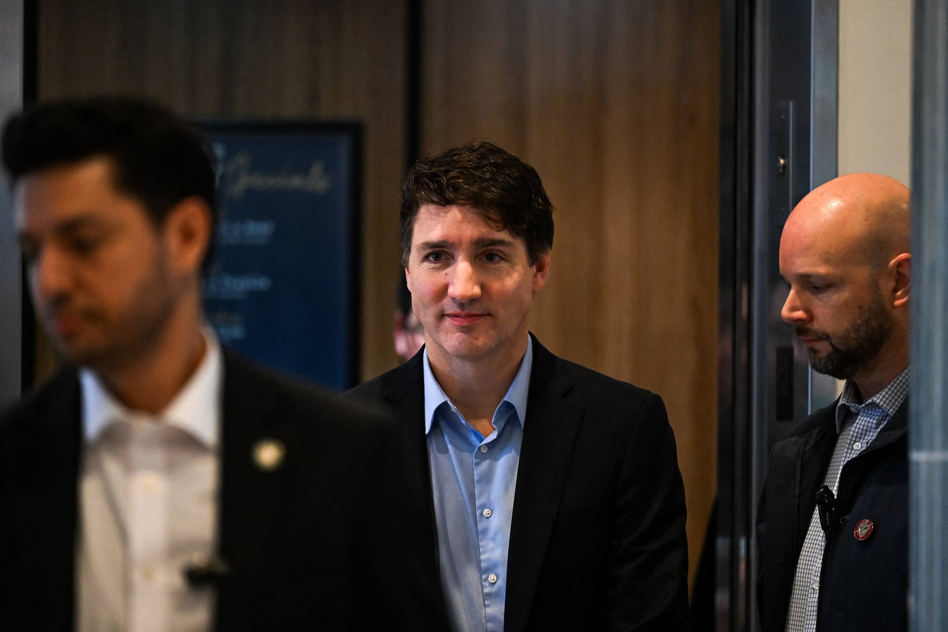 Canadian Prime Minister Justin Trudeau (C) leaves the hotel for the airport, in West Palm Beach, Florida, on November 30, 2024. Canadian Prime Minister Justin Trudeau arrived in Florida on November 29 for a dinner with Donald Trump at the president-elect's Mar-a-Lago estate, as the incoming US leader promised tariffs on Canadian imports. The unannounced meeting comes at the end of a week that has seen Canada as well as Mexico scramble to blunt the impact of Trump's trade threats, which experts have warned could also hit US consumers hard. (Photo by CHANDAN KHANNA / AFP) (Photo by CHANDAN KHANNA/AFP via Getty Images)