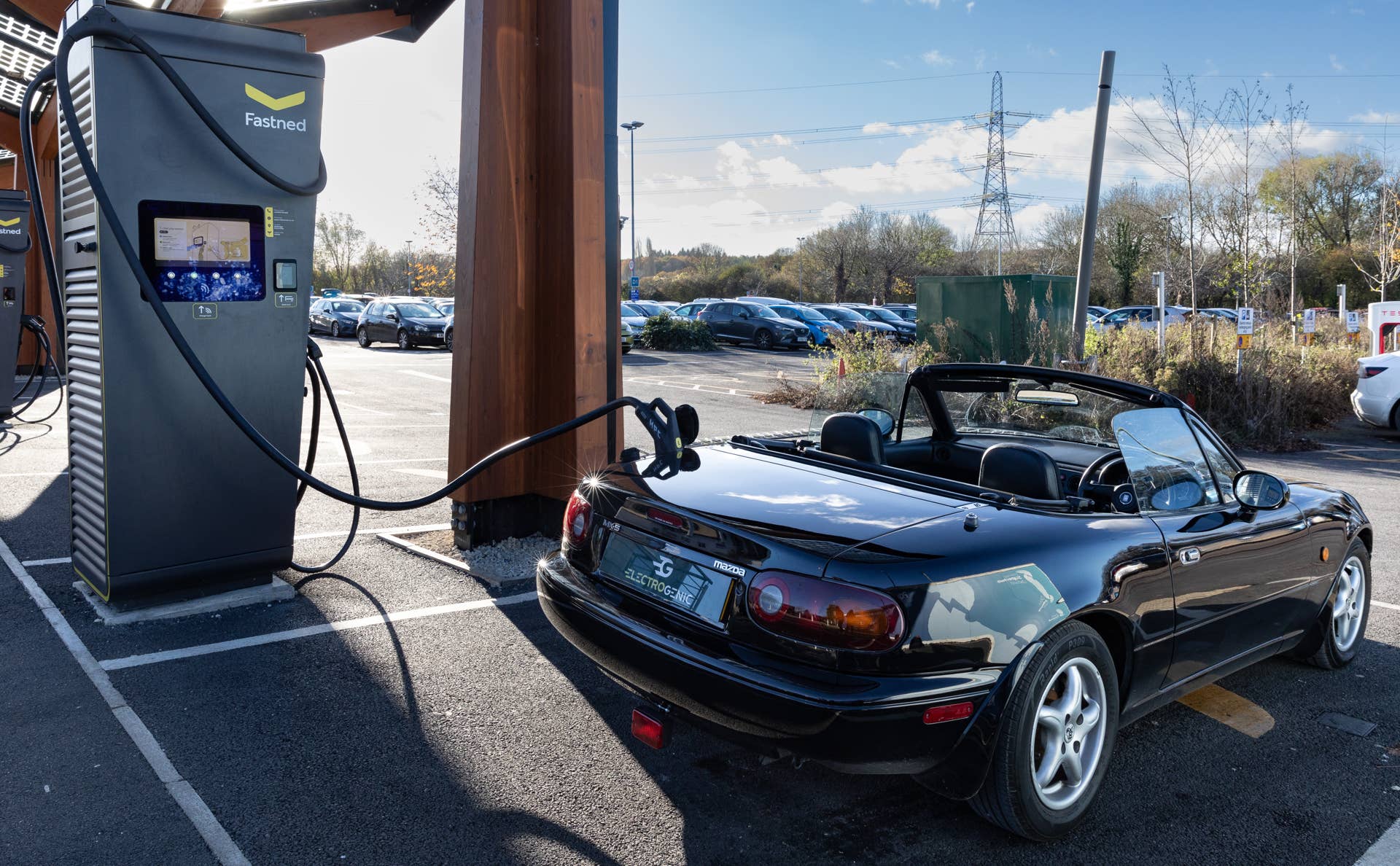 Electrogenic Mazda MX-5 Miata EV at charging station