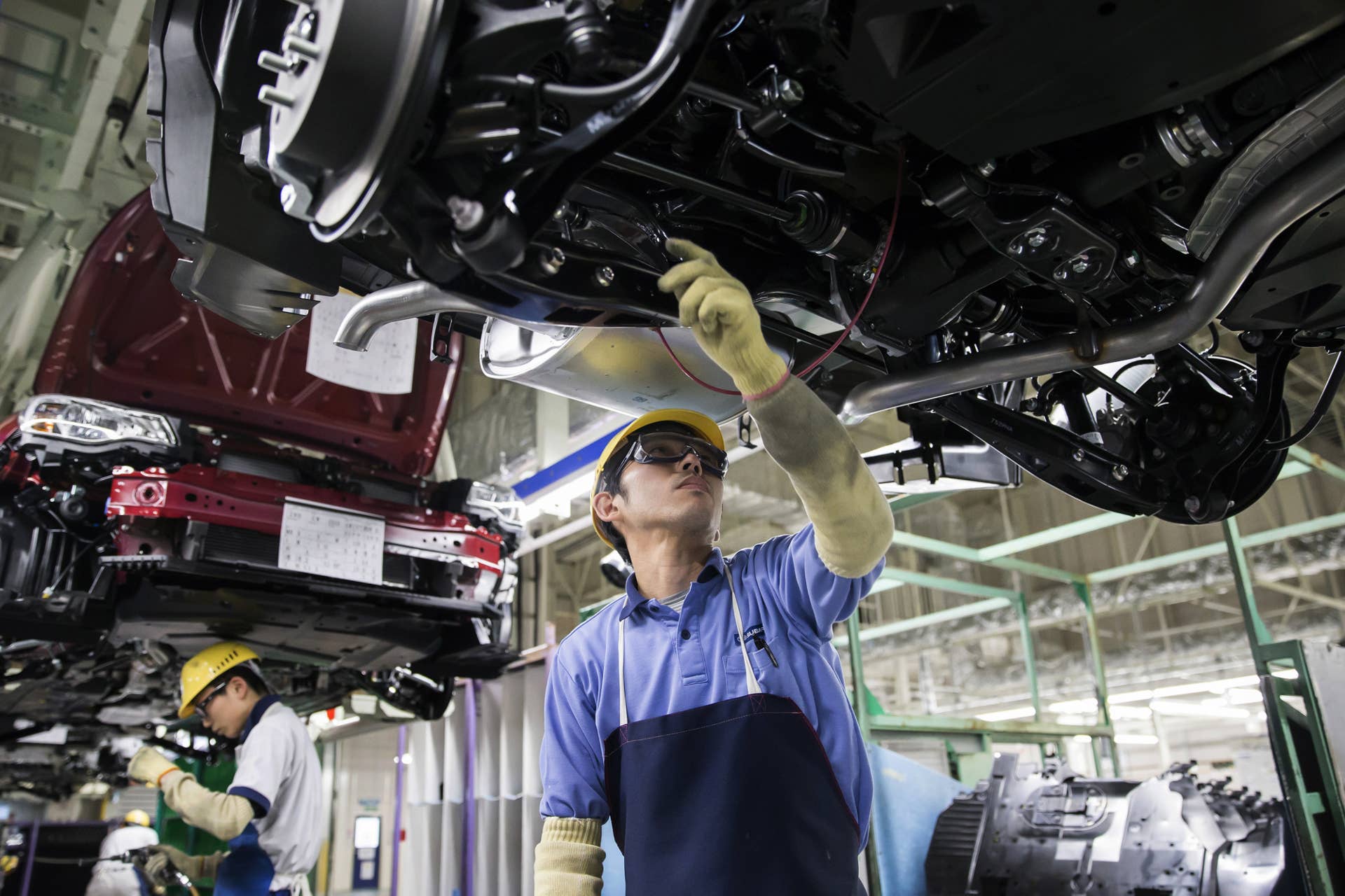 Workers assemble Subaru branded vehicles on the production line of Fuji Heavy Industries Ltd.'s Gunma Yajima Plant in Ota, Gunma, Japan, on Thursday, March 30, 2017. Fuji Heavy, best known for its Subaru brand of cars, will change its name to Subaru Corp. from April 1. Photographer: Tomohiro Ohsumi/Bloomberg via Getty Images