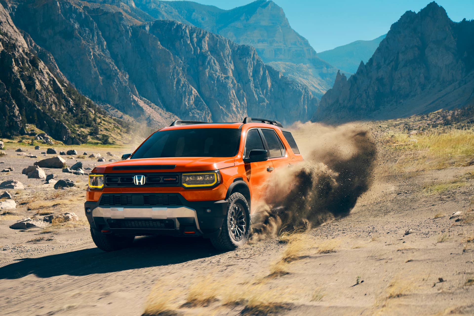 2026 Honda Passport TrailSport in Sunset Orange front angled view sand driving