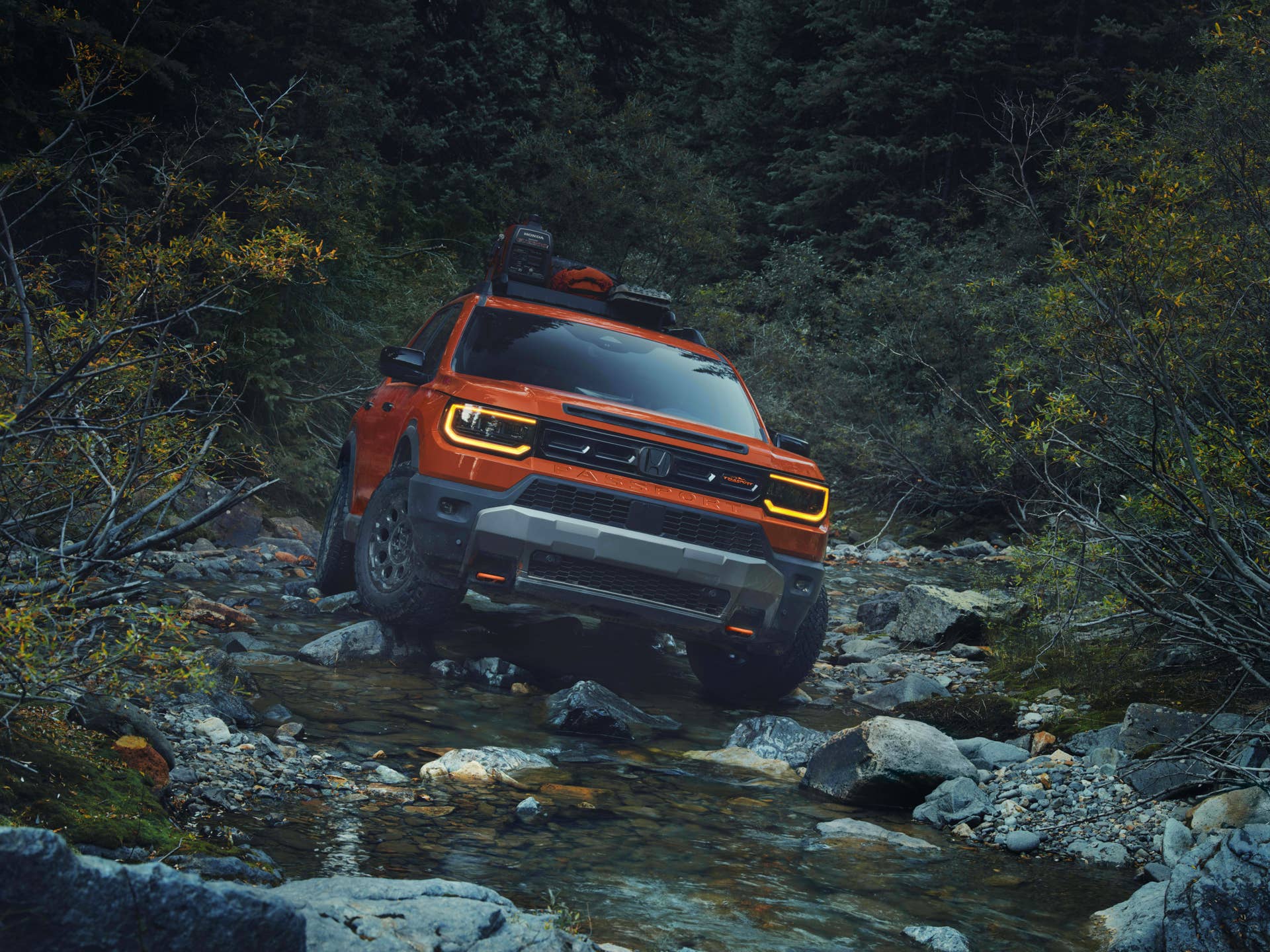 2026 Honda Passport TrailSport in Sunset Orange front view off-road driving
