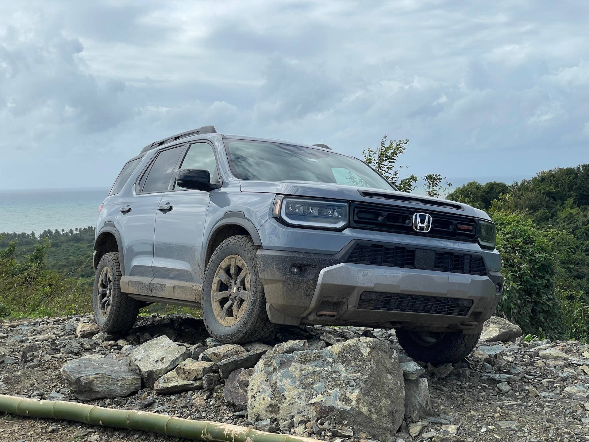 2026 Honda Passport TrailSport in Sonic Gray Pearl front angled view off-road driving