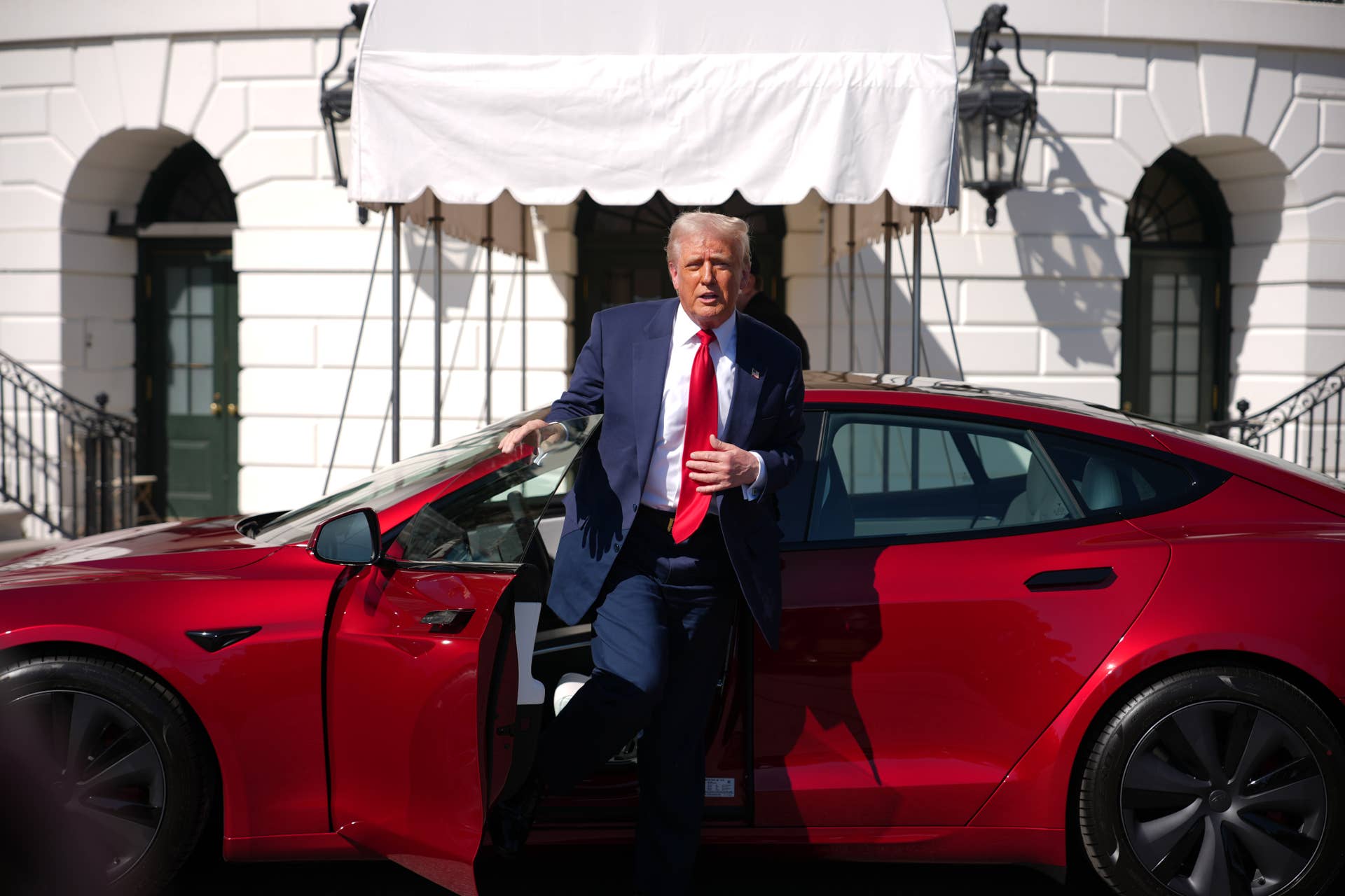 Donald Trump exiting a Tesla Model S