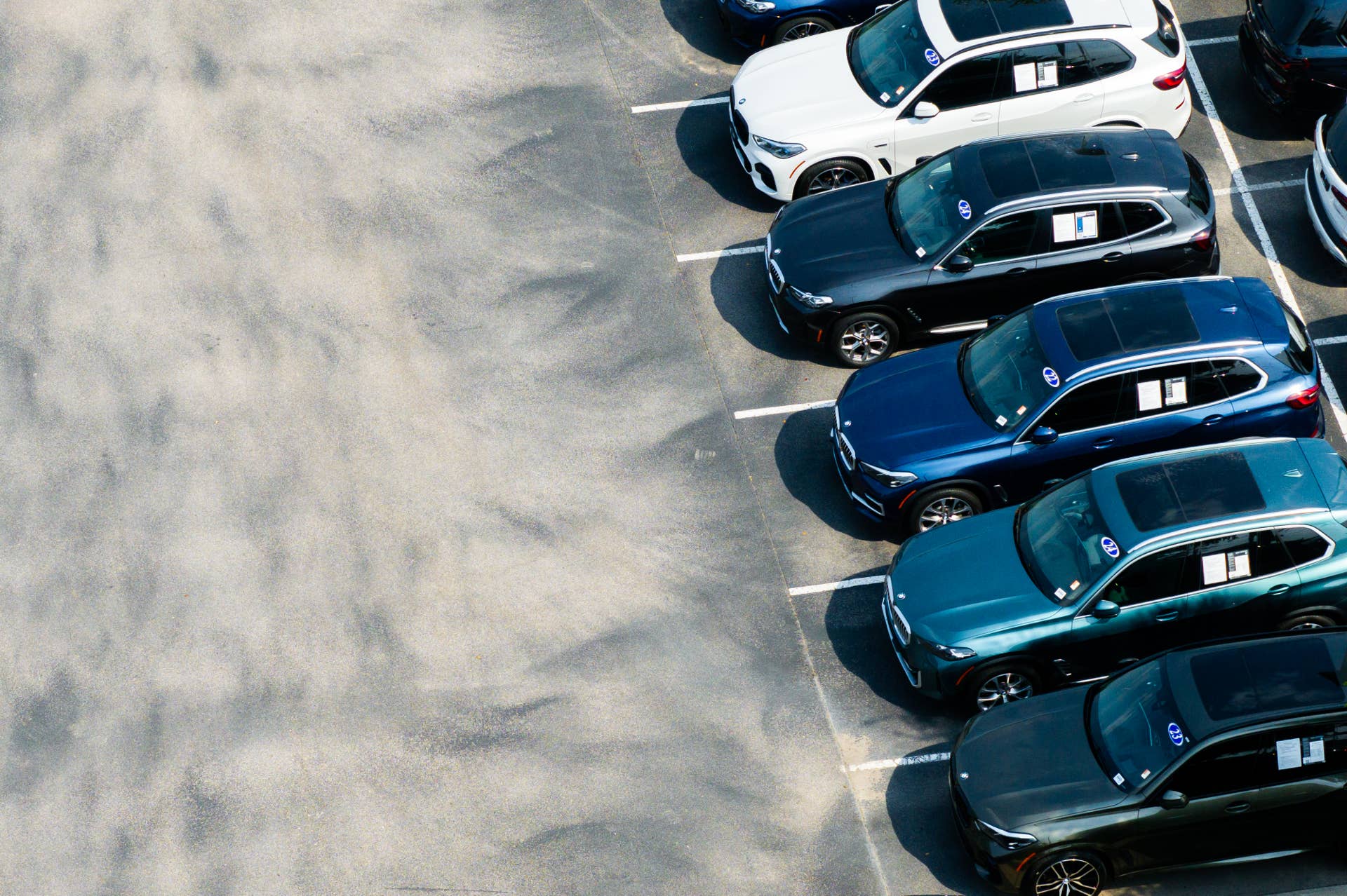 Vehicles are displayed for sale on a lot at the BMW of South Austin dealership