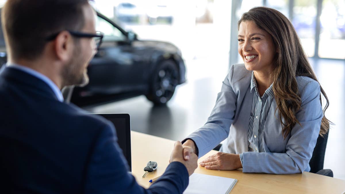 car-dealership-or-documents-with-salesman-and-customer-in-showroom-for-conversation-deal-or-offer-contract-finance-or-insurance-with-agent-and-woman-in-discussion-for-vehicle-purchase.jpg?profile=rss&x=50&y=50