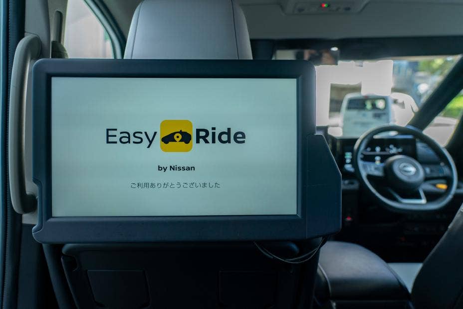 A Serena seatback display shows a screen advertising Easy Ride, Nissan’s autonomous mobility service.