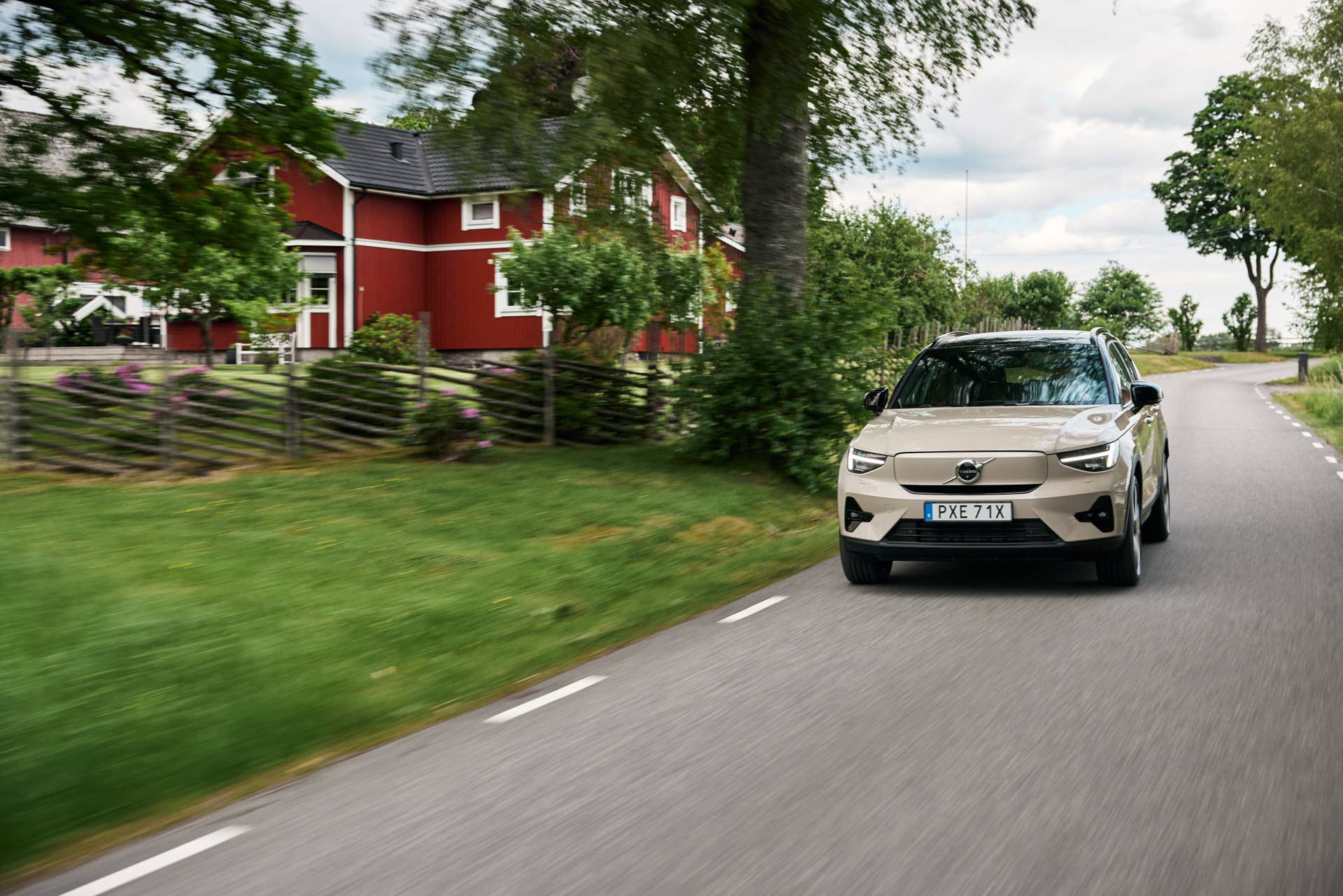 The 2025 Volvo EX40 Twin Motor Ultra driving down a country road