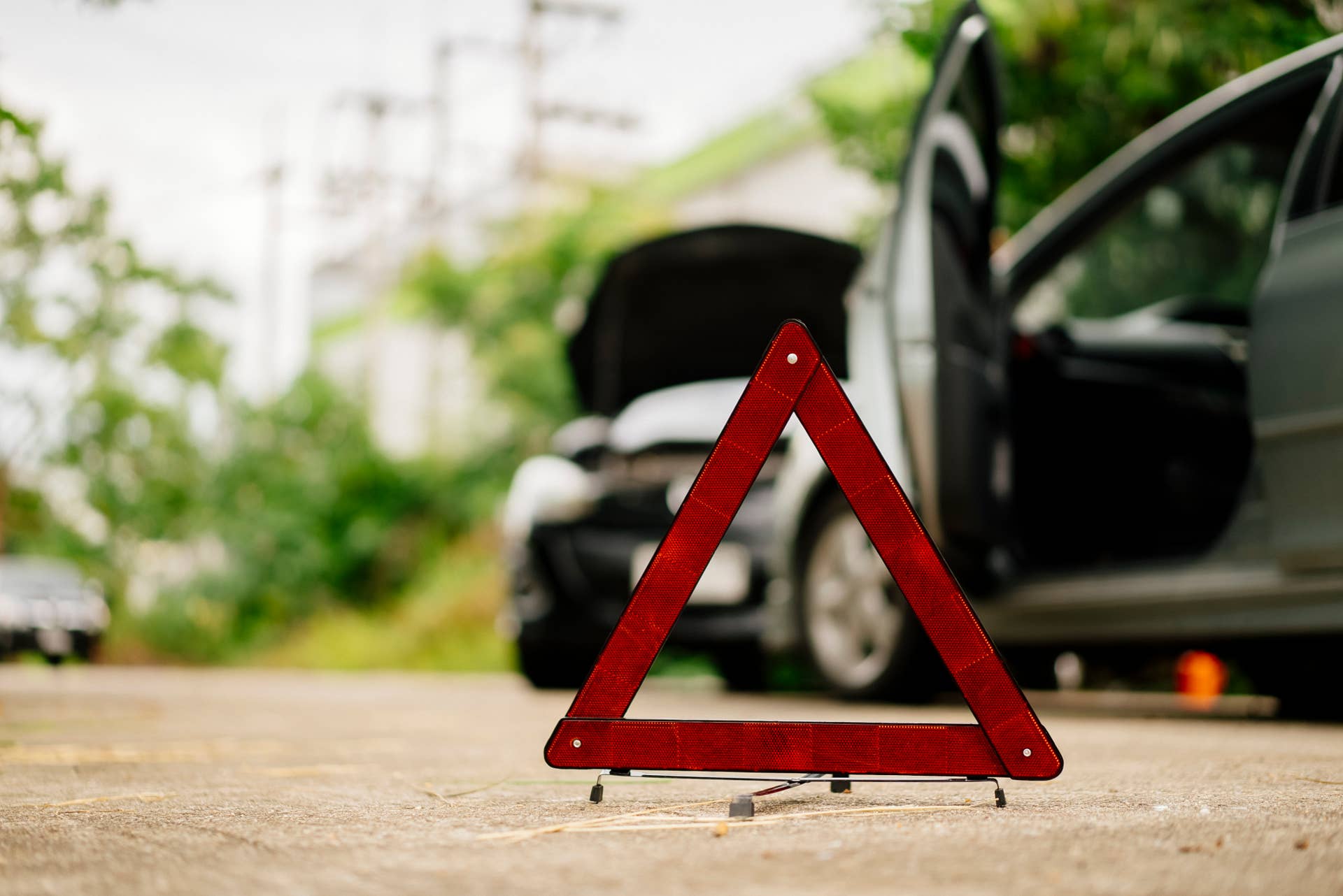 A roadside warning triangle marking a car accident